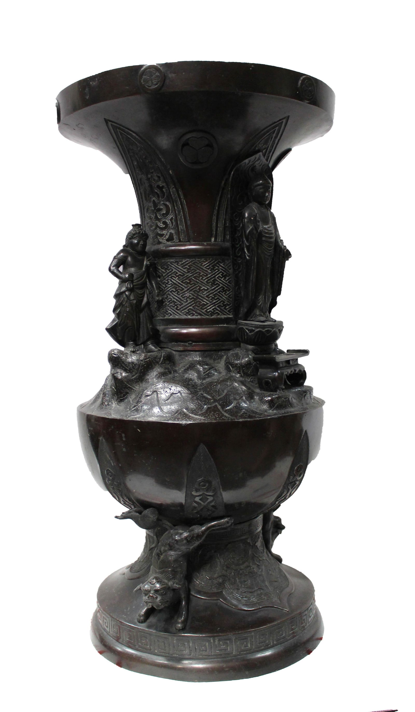 A Large Japanese Bronze Floor Vase, Meiji Period: Mounted with a figure of Buddha and three figural attendants below a wide flared rim, embossed with Ming style designs, raised on a bell form base with two figural Buddhist lions. Base plate absent.