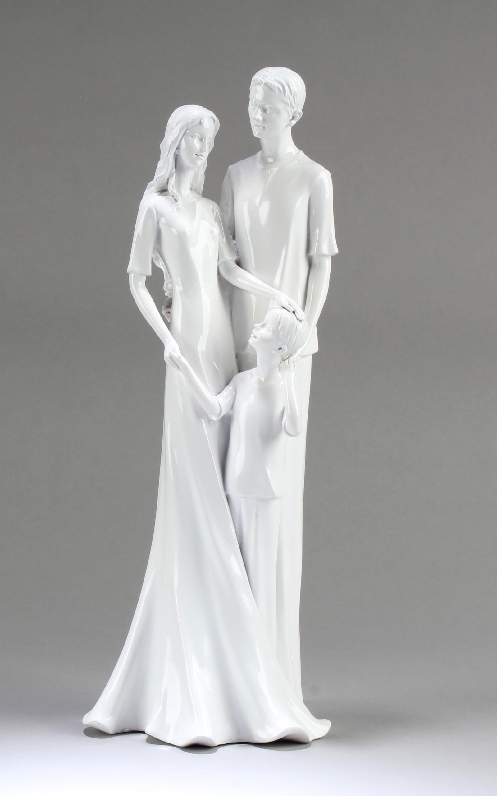 A Porcelain Figurine: A Porcelain Figurine of a man, woman and child. Height: 13"