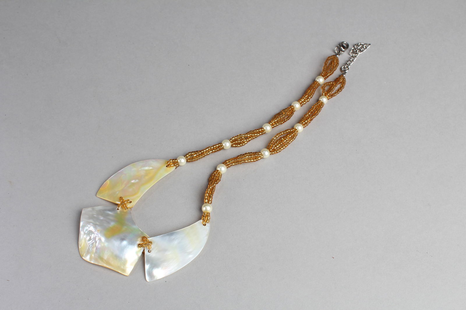 A Three Piece Mother Pearl Necklace: A Three Piece Mother Pearl Necklace. Length: 9"