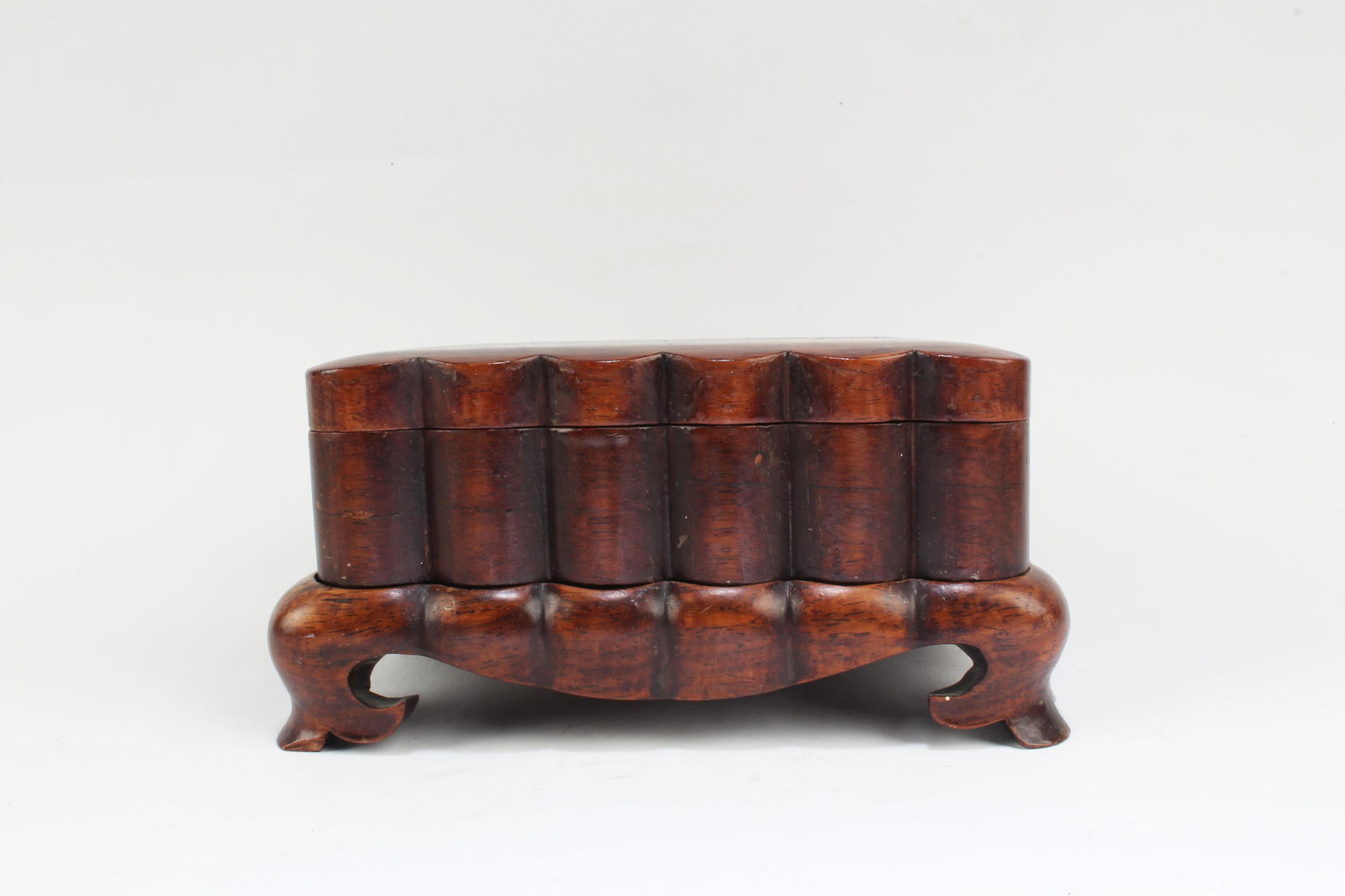 A Carved Hardwood Ink Box: A Carved Hardwood Ink Box. Comes fitted with a wooden stand. Length: 5.5" Width: 4.5" Height: 2.8"Provenance: From an estate sale in Hollywood, California.
