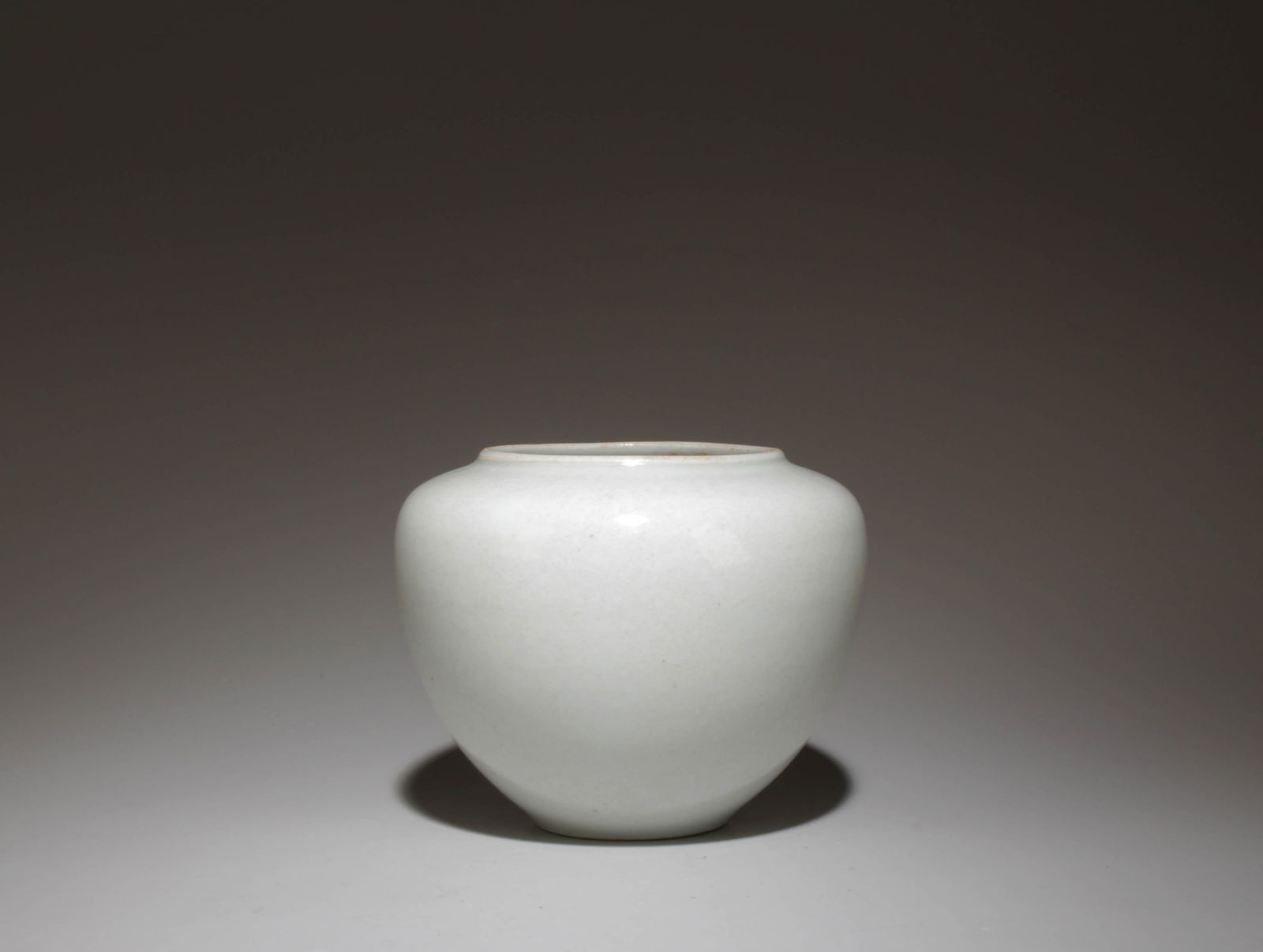 A White Glazed Jar: A White Glazed Jar. Dimensions: 4.1" x 3.25".