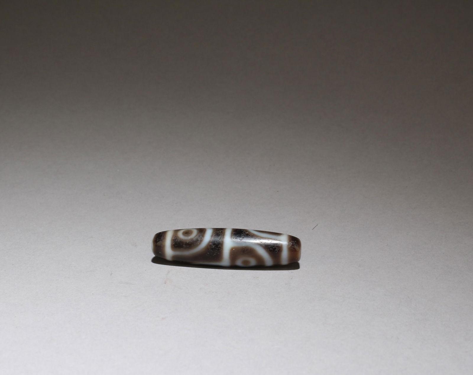 A Dzi Bead: A Dzi Bead. Length: 1.6"