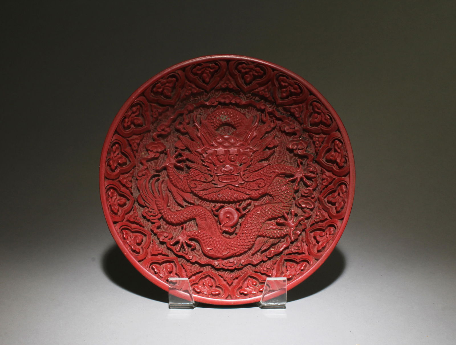 A Cinnabar Plate: A Cinnabar Plate, "QianLong" mark at base. Diameter: 8"