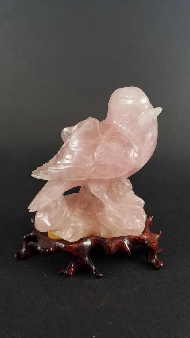 A Carved Lavender Crystal Bird Figurine: A Carved Lavender Crystal Bird Figurine. Comes fitted with a wooden stand. Length: 3" Height: 4"