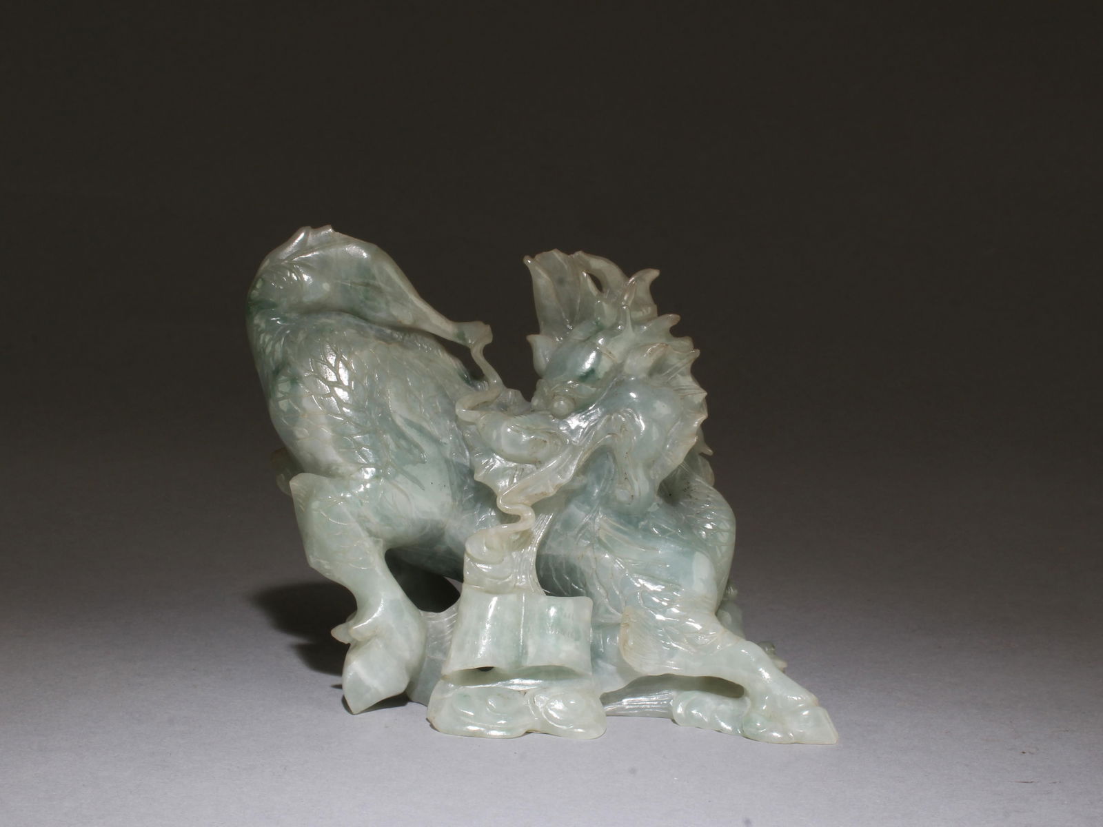A Carved Jade Figurine: A Carved Jade Figurine. Length: 4.25" Height: 3.5"