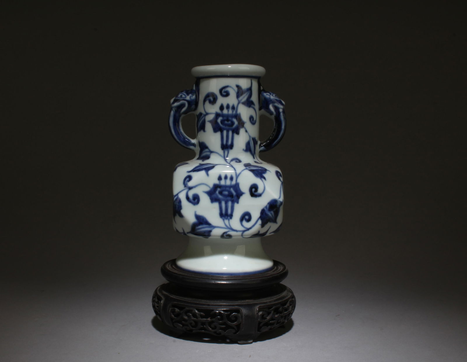 A Blue and White Vase with Stand: A Blue and White Vase with Stand. Item Dimensions: 6.5" x 3.5, Stand Dimensions: 2" x 4.75".