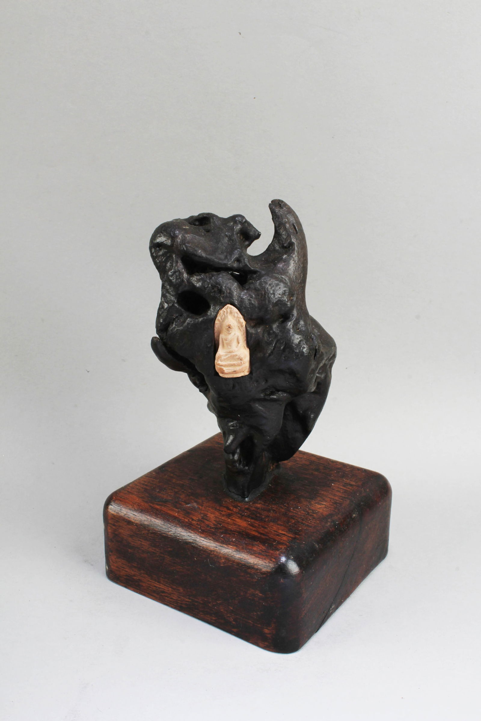 A Carved Buddha Statue Enclosed within QiMu Sculpt: A Carved Buddha Statue Enclosed within QiMu Sculpture. Height: 5" (with stand)