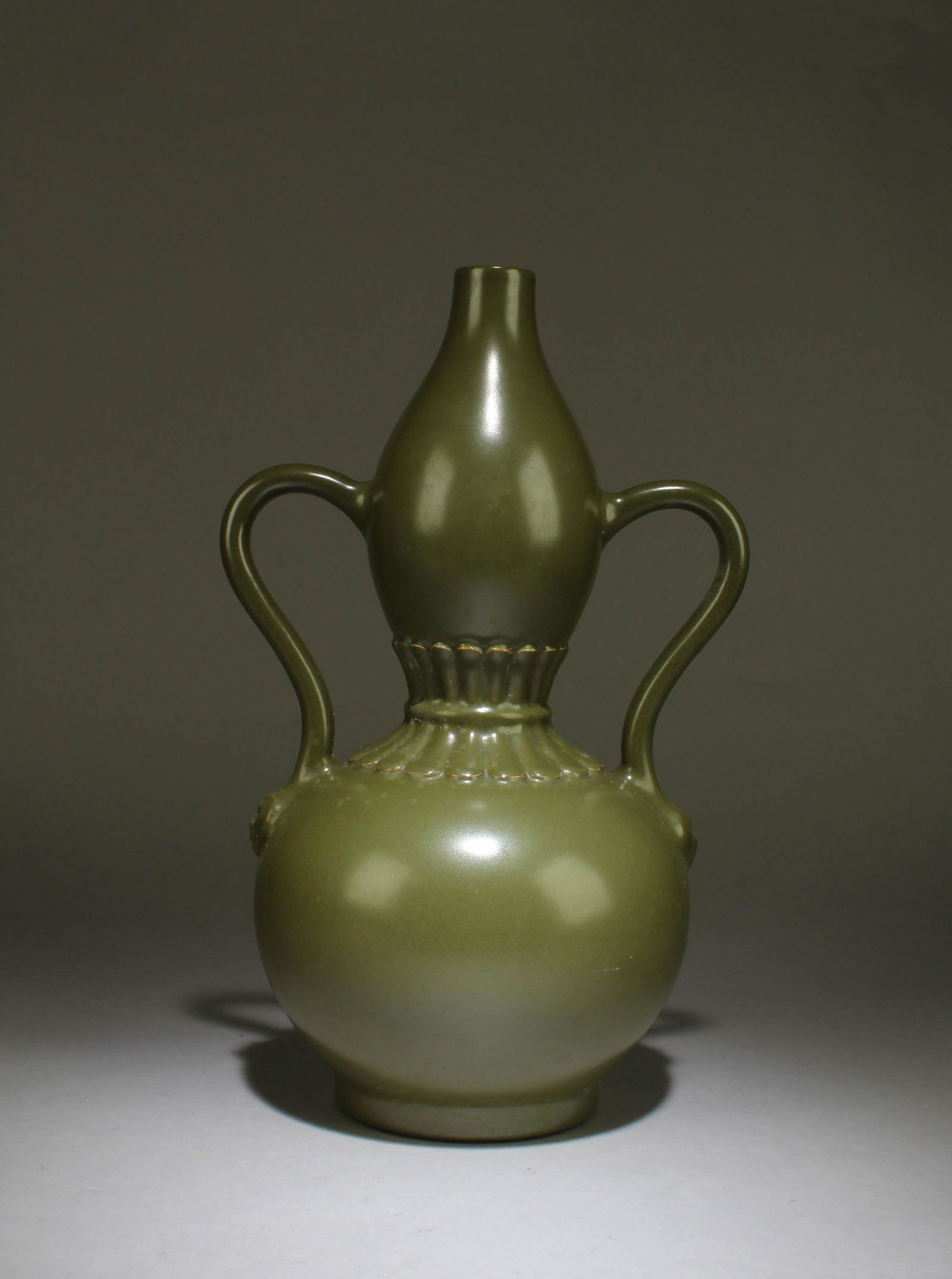 A Tea Dust Color Porcelain Vase: A Tea Dust Color Porcelain Vase. 'QianLong'mark at base. Height: 12.2" Length: 8"