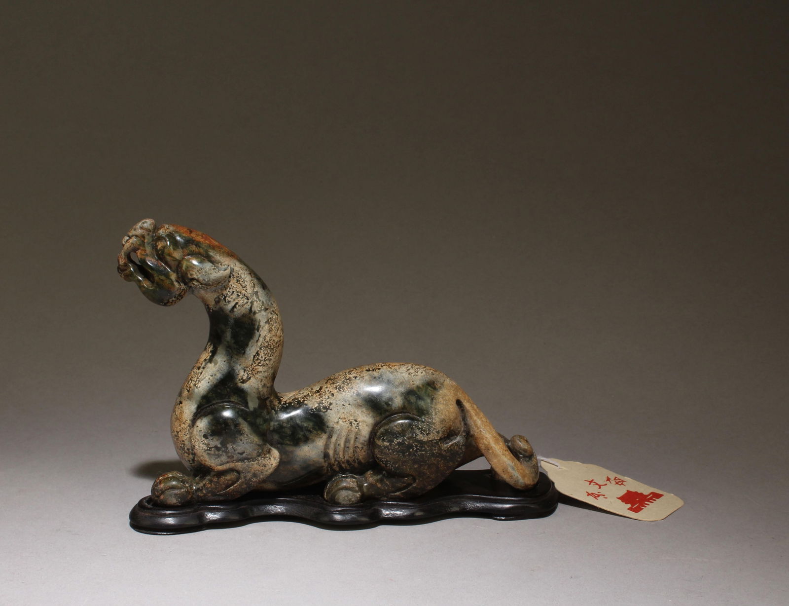 A Carved Jade Mythical Beast Figurine: A Carved Jade Mythical Beast Figurine with wooden stand. Dimension with stand: 5.75" x 4"