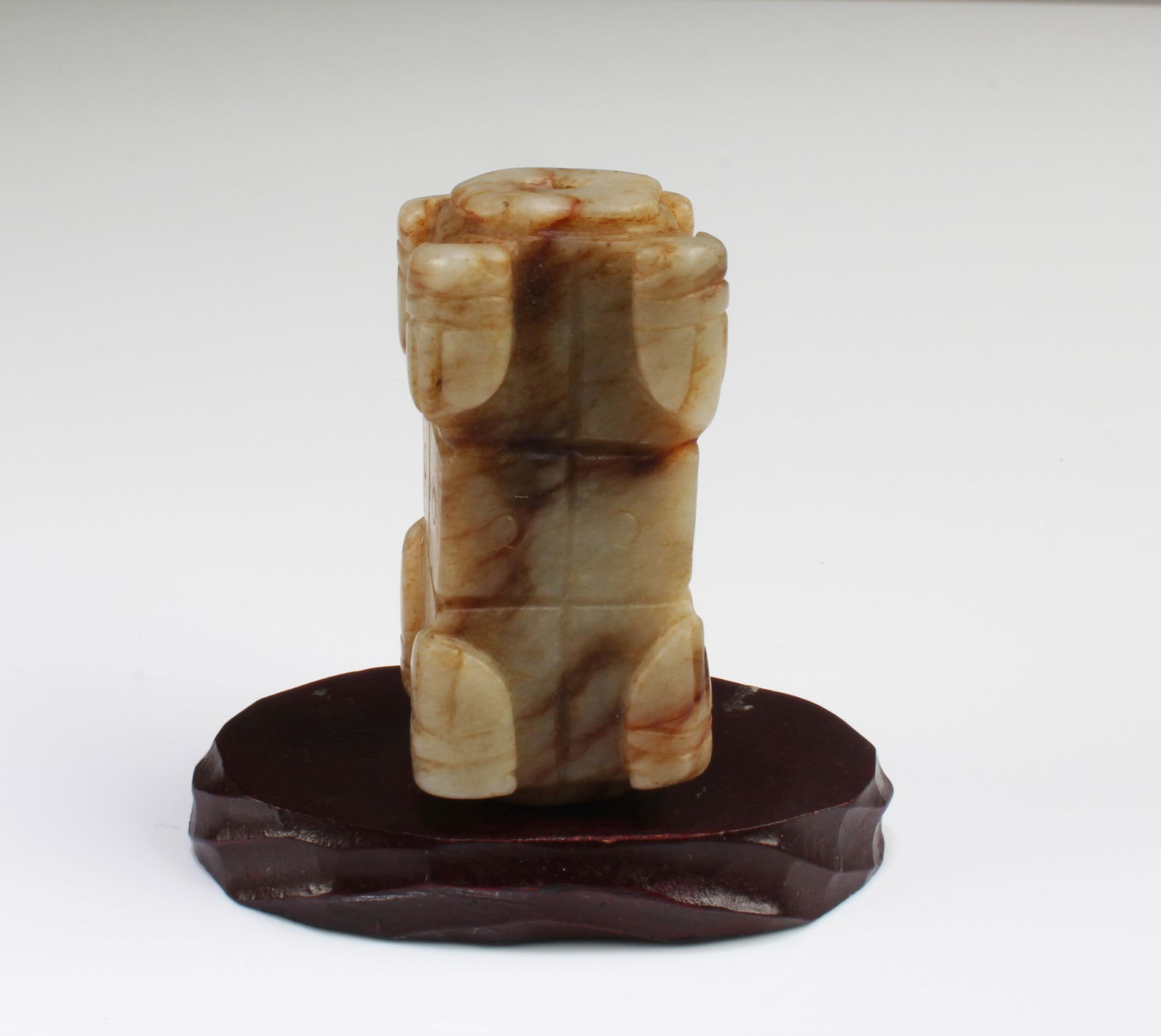 A Jade Ornament: A Jade Ornament. Comes fitted with a wooden base. Height: 1.75"