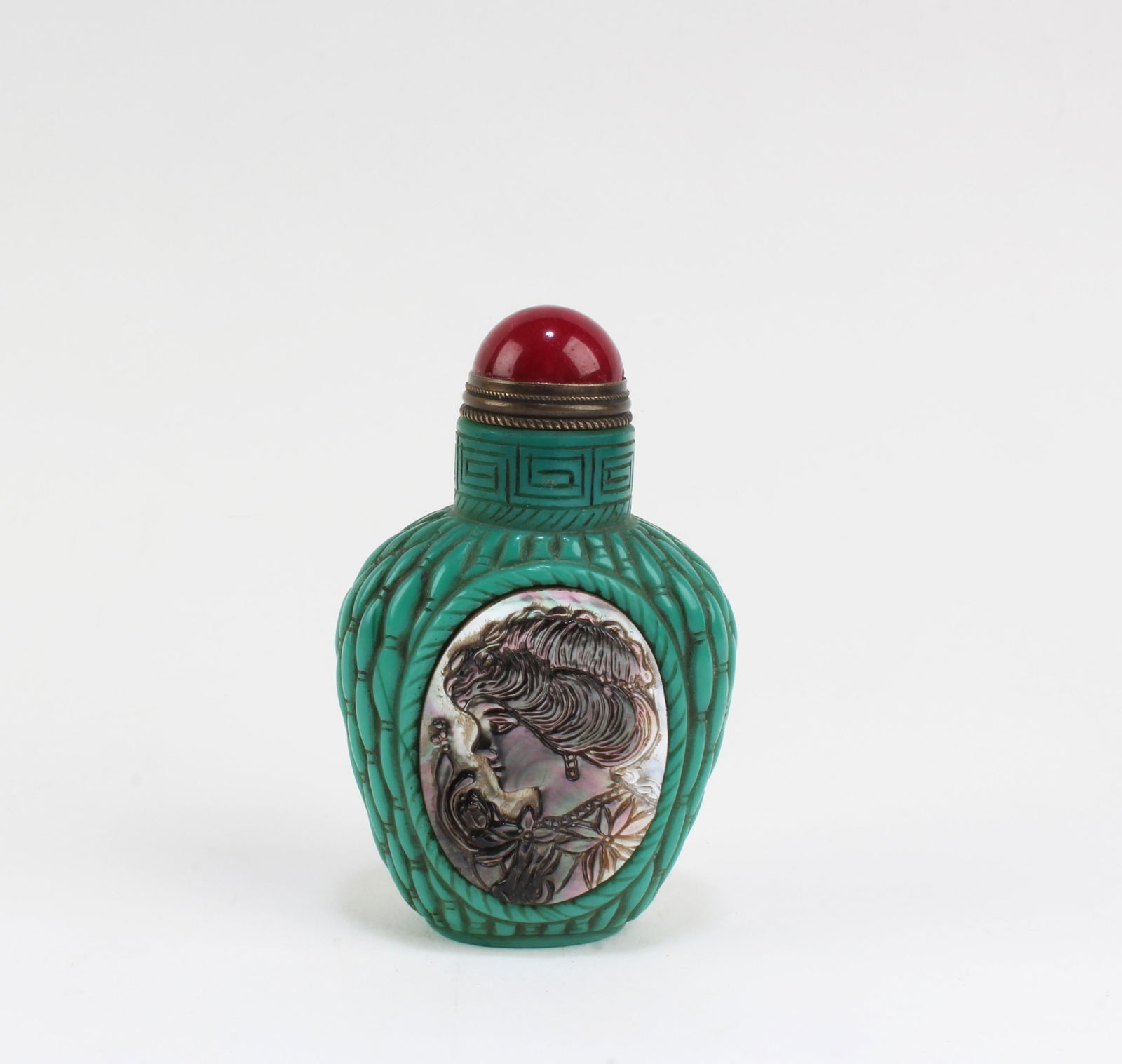 A Peking Glass Snuff Bottle: A Peking Glass Snuff Bottle, the body decorated with mother-of-pearl inlay. 'QianLong' mark. Height: 2.75"
