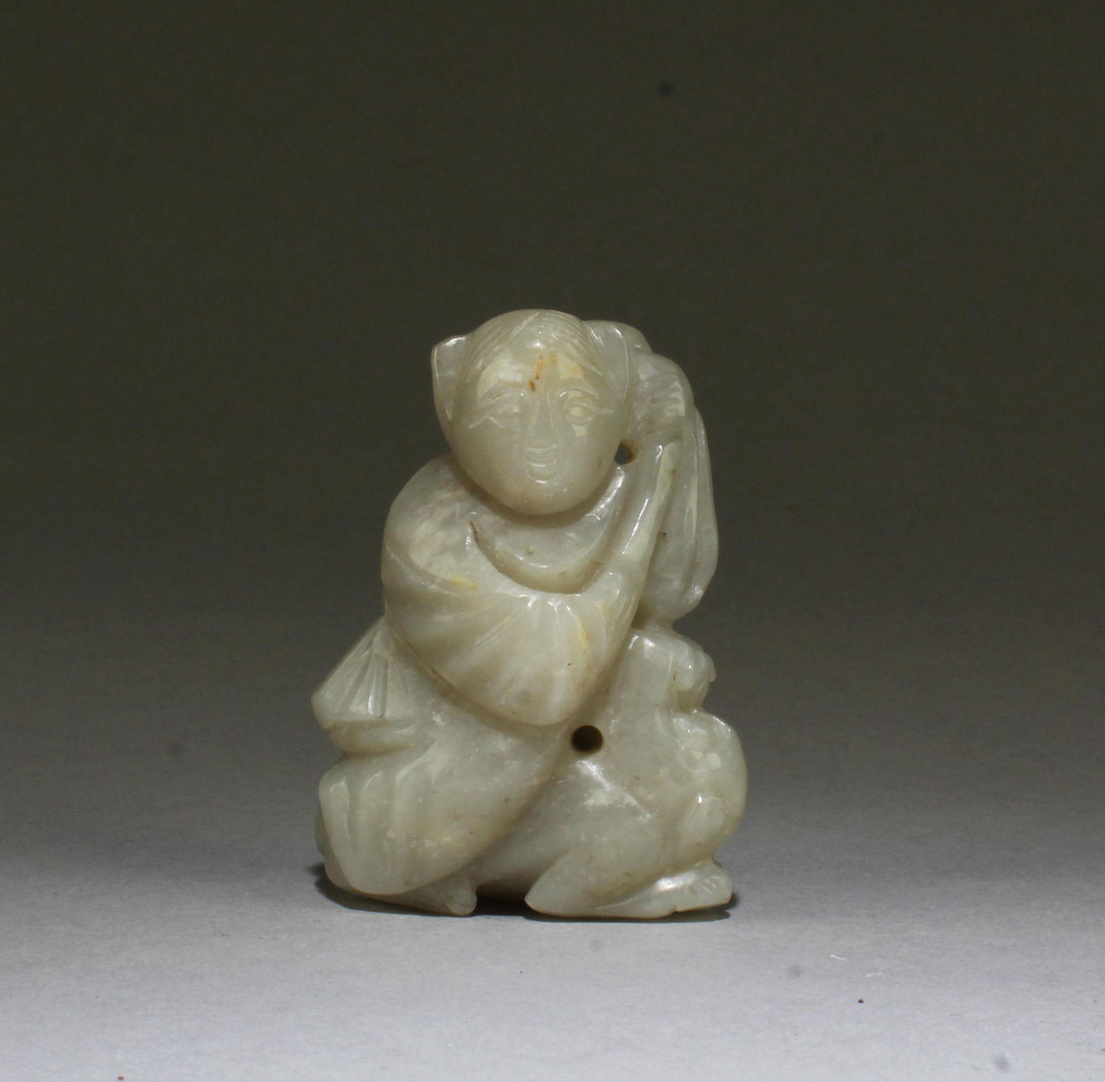 A Carved Hetian Jade Ornament: A Carved Hetian Jade Ornament. Length: 2.5"