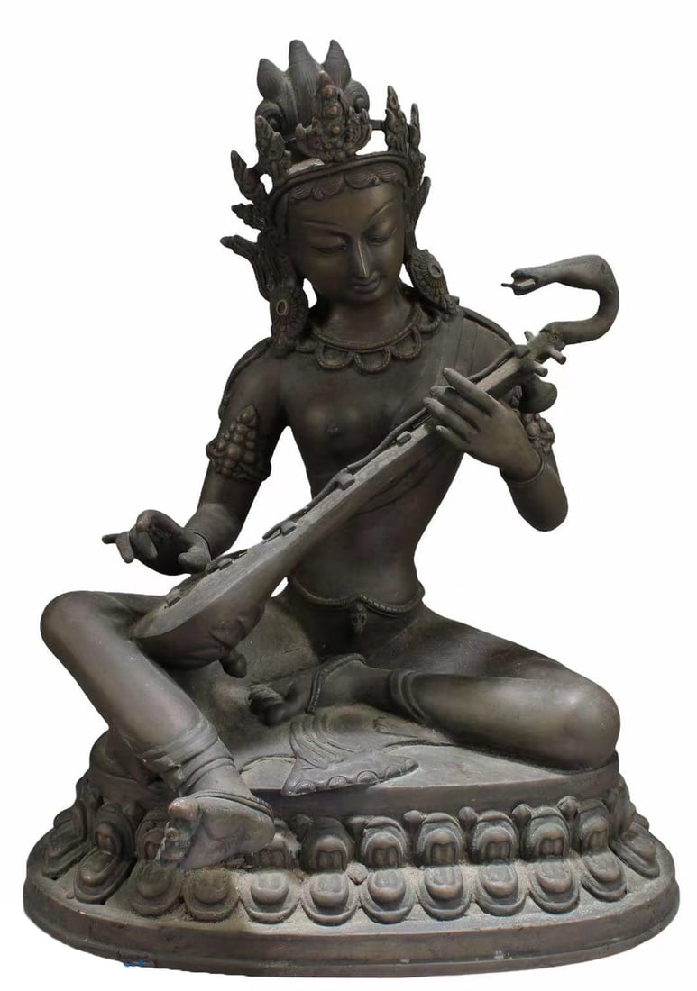 Indian Bronze Seated Figure: Indian bronze seated figure of Saraswati; holding a veena and seated atop a lotus base; H: 12" (approx.)