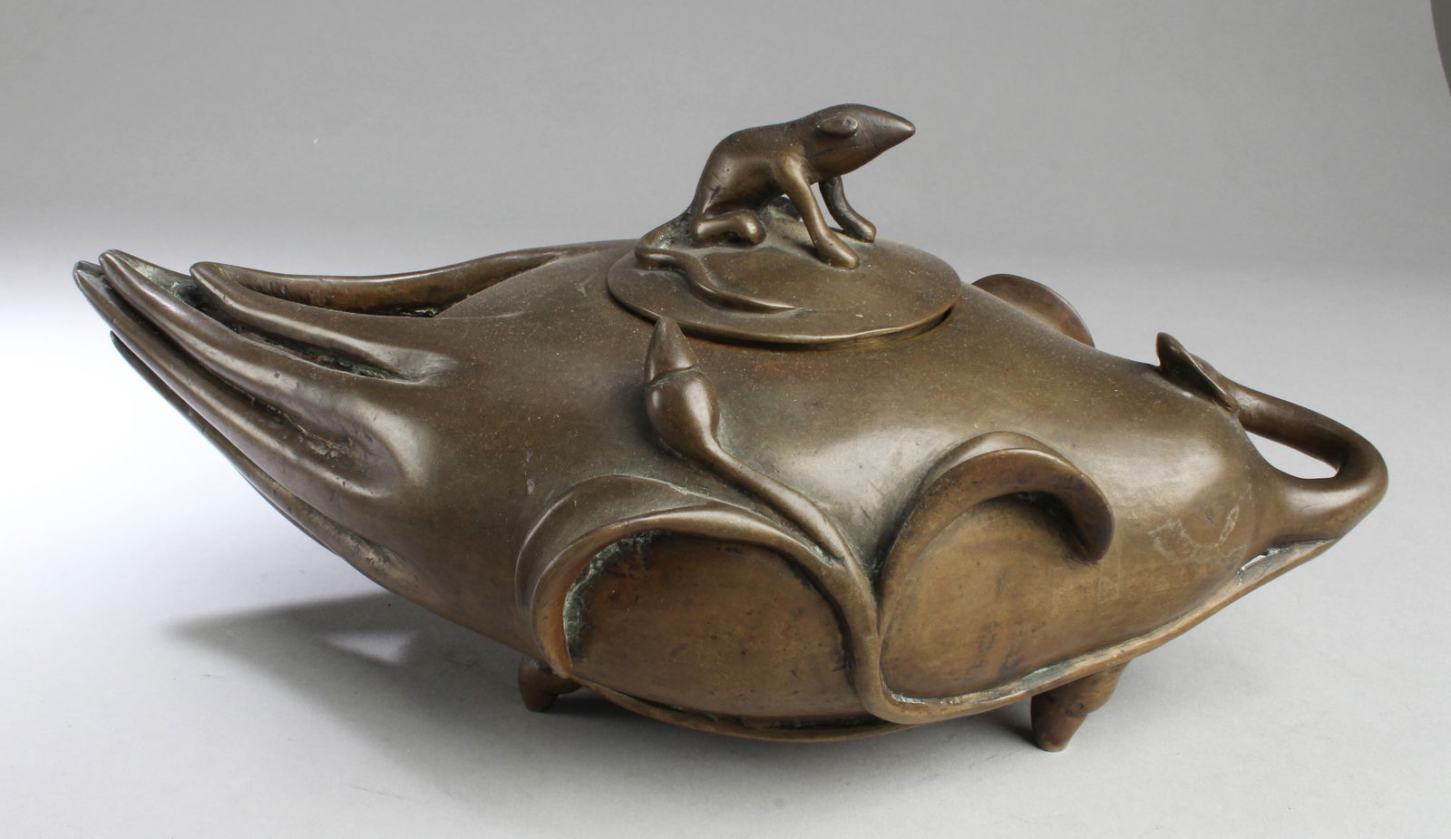 A Bronze Tripod Pot: A Bronze Tripod Pot. Length: 12"