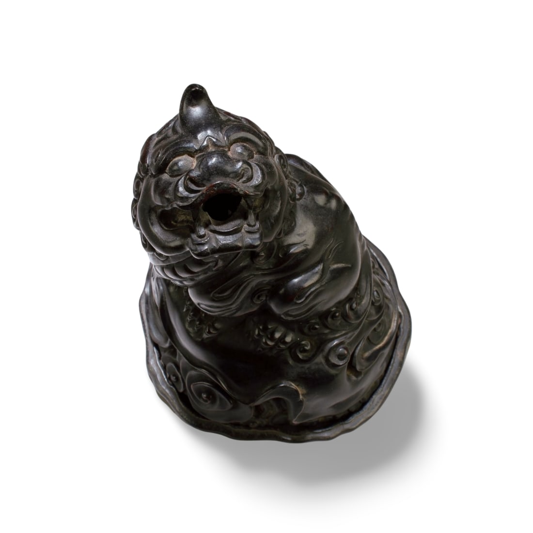 A Chinese Carved Hardwood Mythical Beast Figurine: Chinese Carved Hardwood Mythical Beast Figurine with Stand. Height: 7"