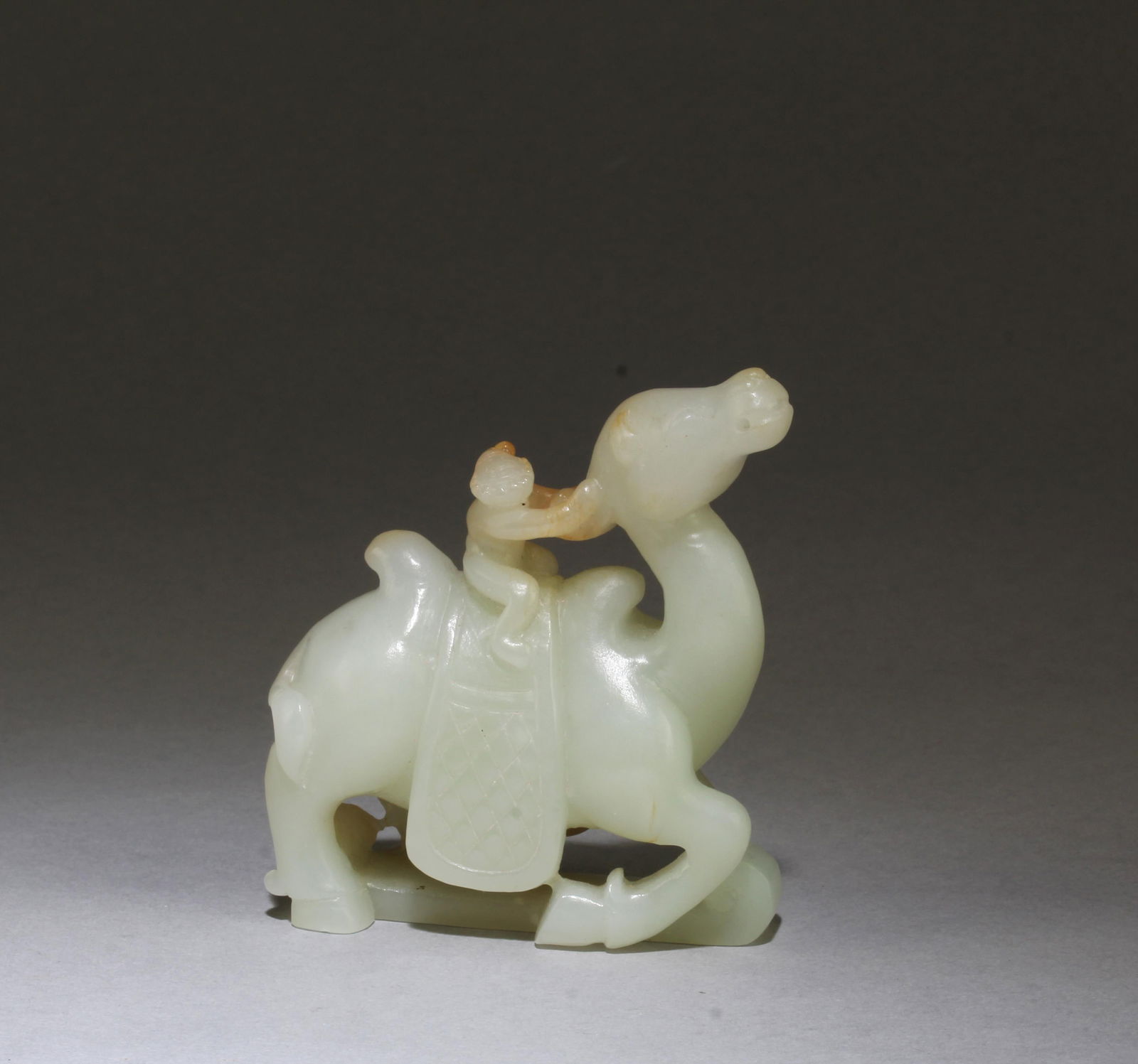 A Carved Camel Jade Ornament: A Carved Camel Jade Ornament. Length: 3"