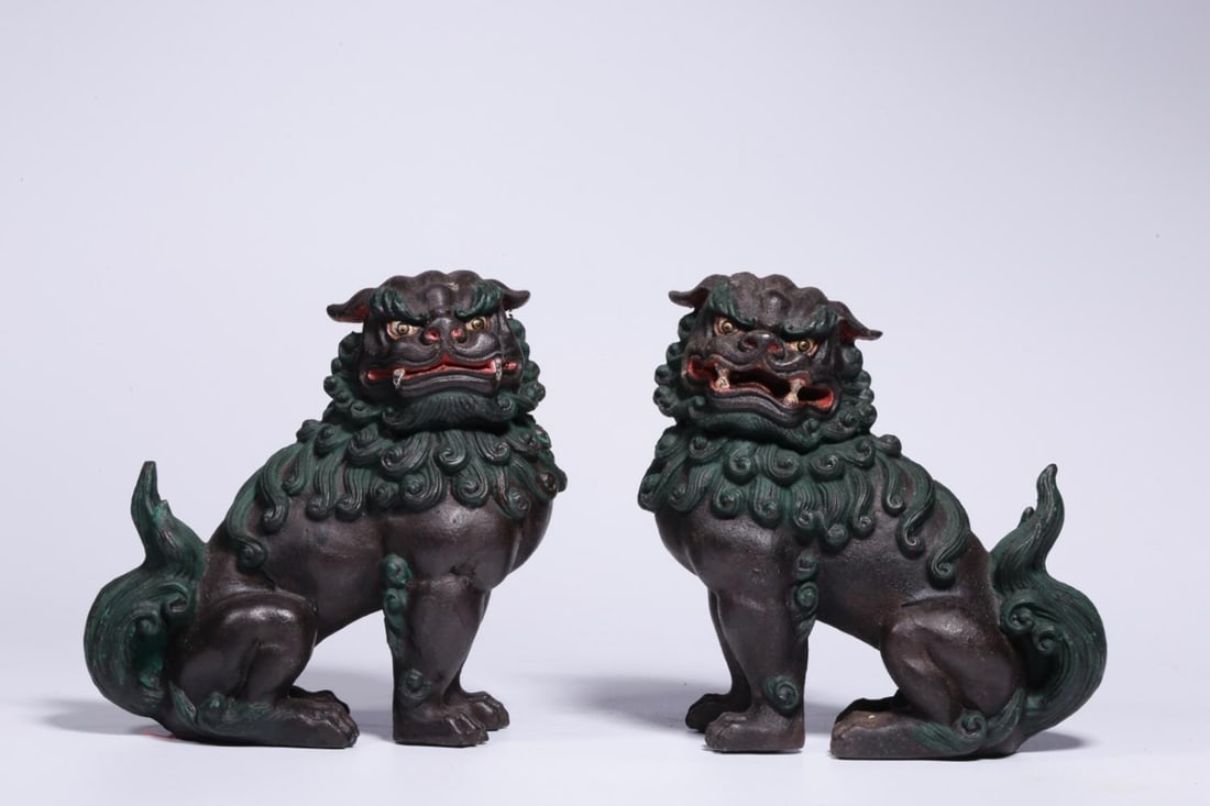 A Pair of Lacquered Iron Lion Ornaments: A Pair of Lacquered Iron Lion Ornaments. Dimensions: 5.12" x 5.12" x 2.76"; Weight: 3.73lbs.