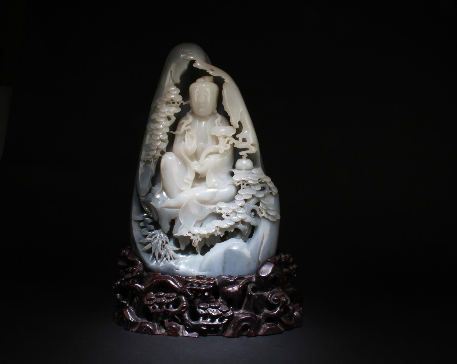 A Massive Carved Hetian Jade Guanyin: A Massive Carved Hetian Jade Guanyin with Fitted Stand . Dimensions without Stand: 15" x 10" x 4.75". Dimensions with Stand: 18" x 13" x 6.5".