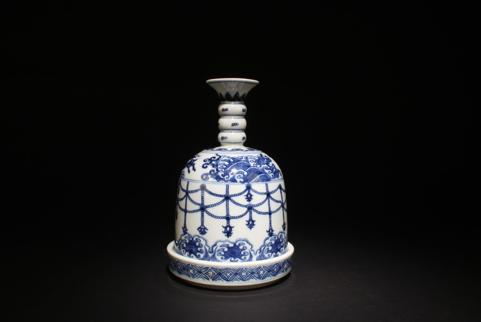 A Blue and White Bell-Shaped Ornament: A Blue and White Bell-Shaped Ornament . Dimensions: 7.75" x 5.1".