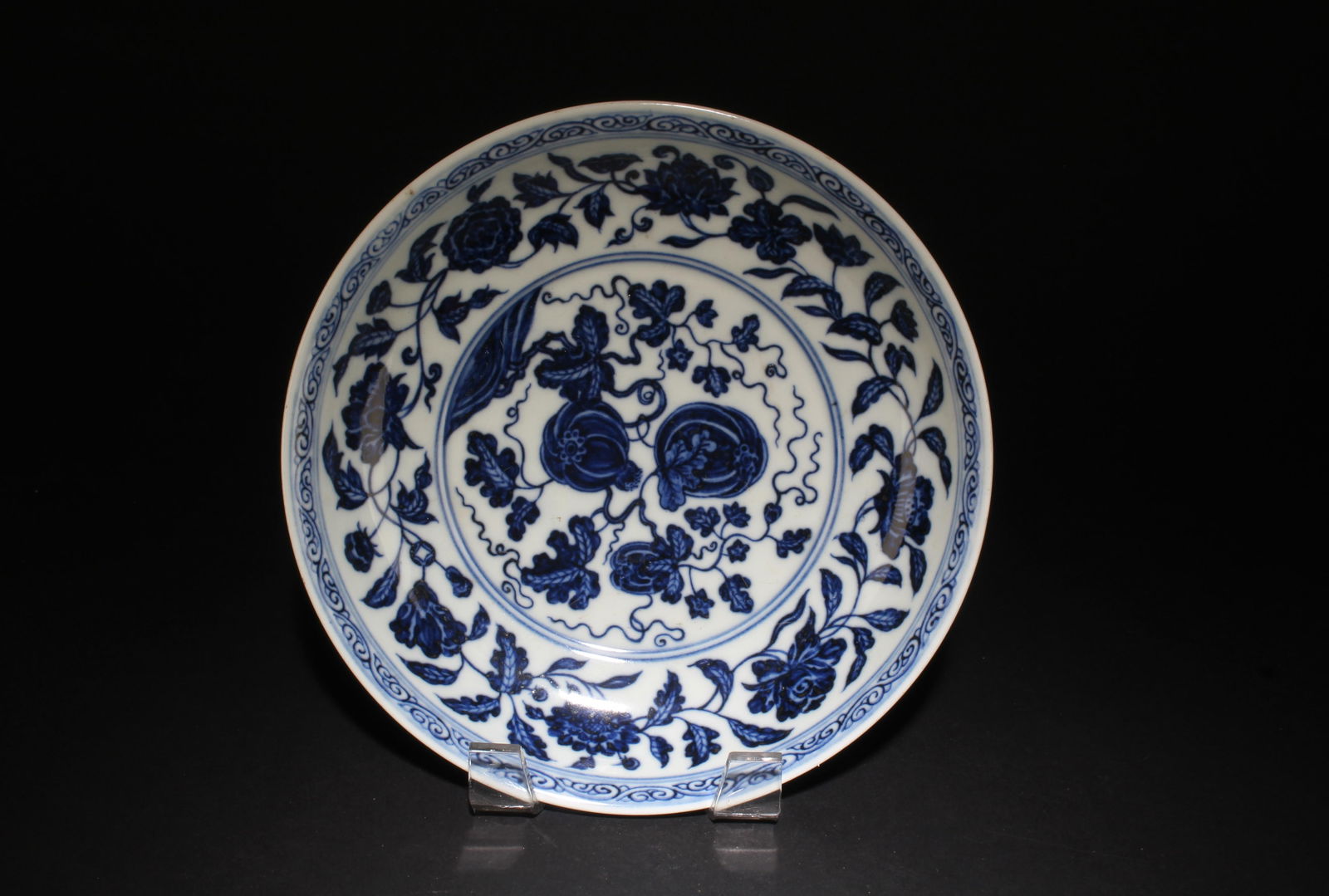 A Blue and White Plate with Flower Motif: A Blue and White Plate with Flower Motif. Dimensions: 8" x 1.6".