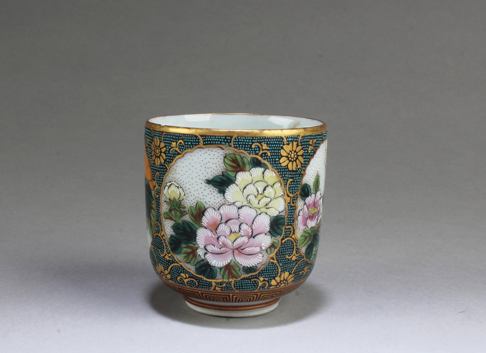 A Japanese Porcelain Wine Cup: A Japanese Porcelain Wine Cup. 'JiuGu' mark at base. Height: 2.5" Diameter: 2.25"