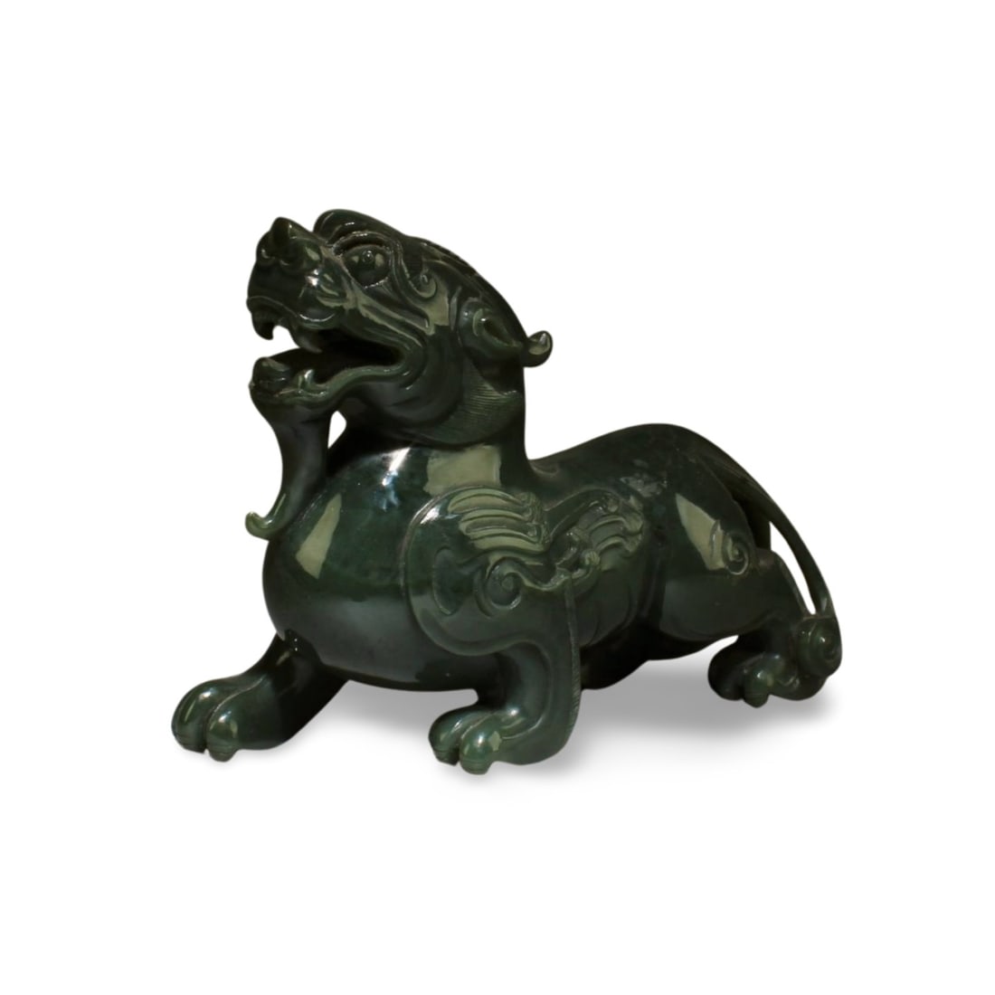 Chinese Spinach Green Nephrite Jade Carved Ornamen: Chinese Spinach Green Jade Carved Ornament, depicting a intricately carved mythical creature, showing it's mouth, teeth, mane, in sitting position. Length: 6.25 "