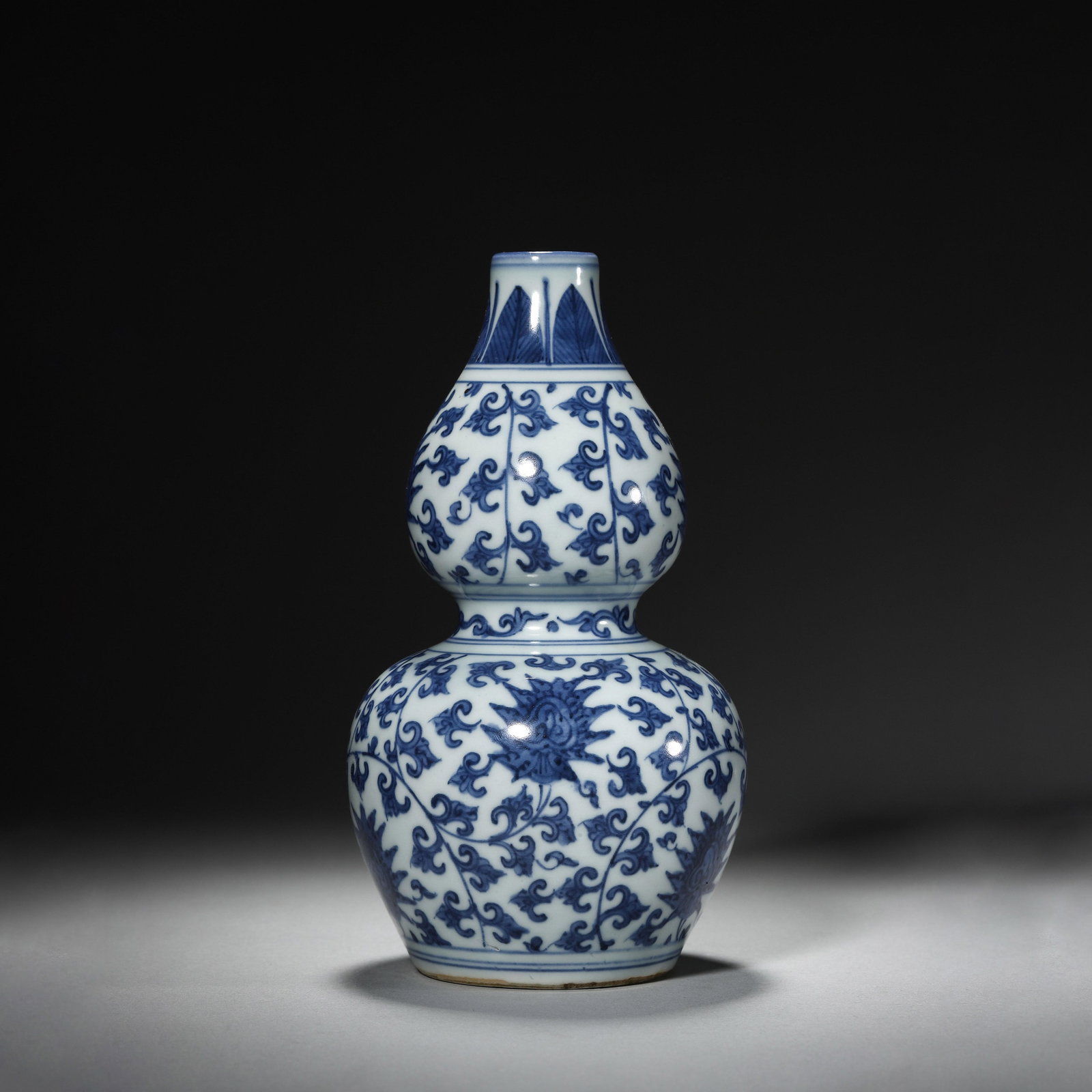 Blue and White Gourd Vase with Lotus Motif: Blue and White Gourd Vase with Lotus Motif. Diam: 3.94" Height: 7.28"