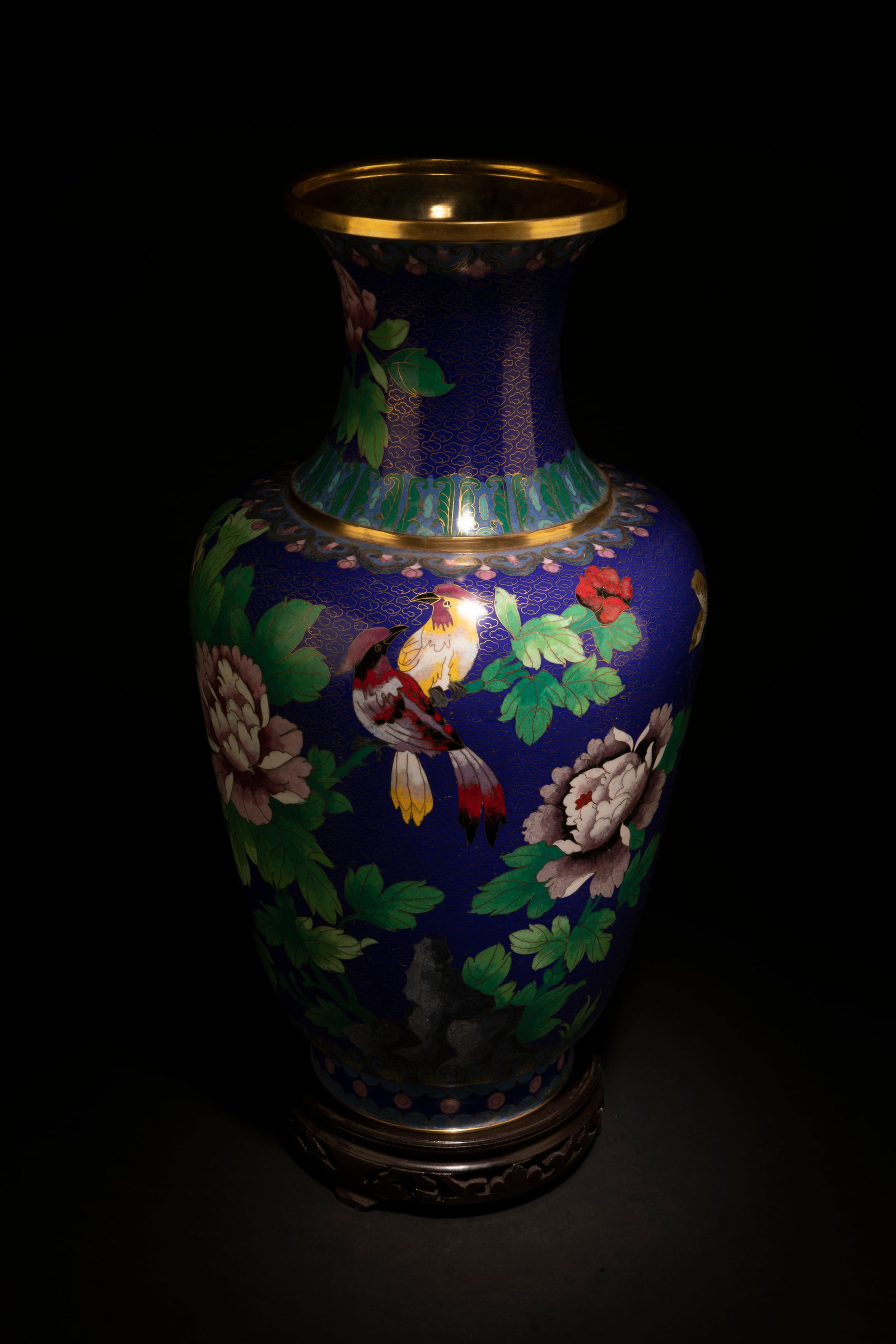 A Cloisonne Vase: A Cloisonne Vase. Comes fitted with a wooden stand. Height: 20"