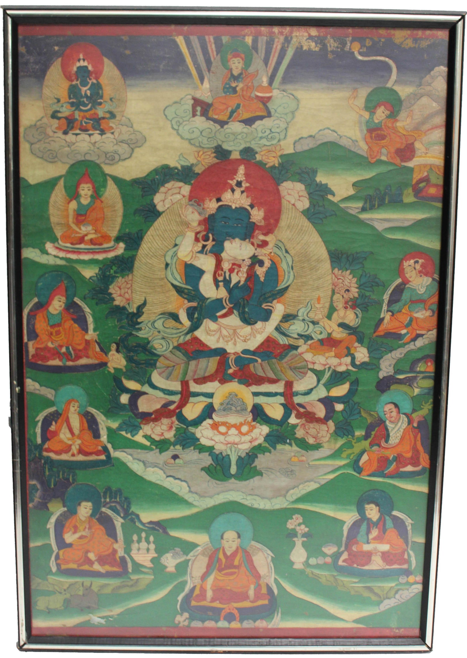 A Framed Tibetan Thangka: A painted paper thangka; centering a seated deity, set before a floral-motif mandorla; framed by smaller lamas within a green hilly landscape; 29 3/4" x 19 3/4" (sight, approx.); framed