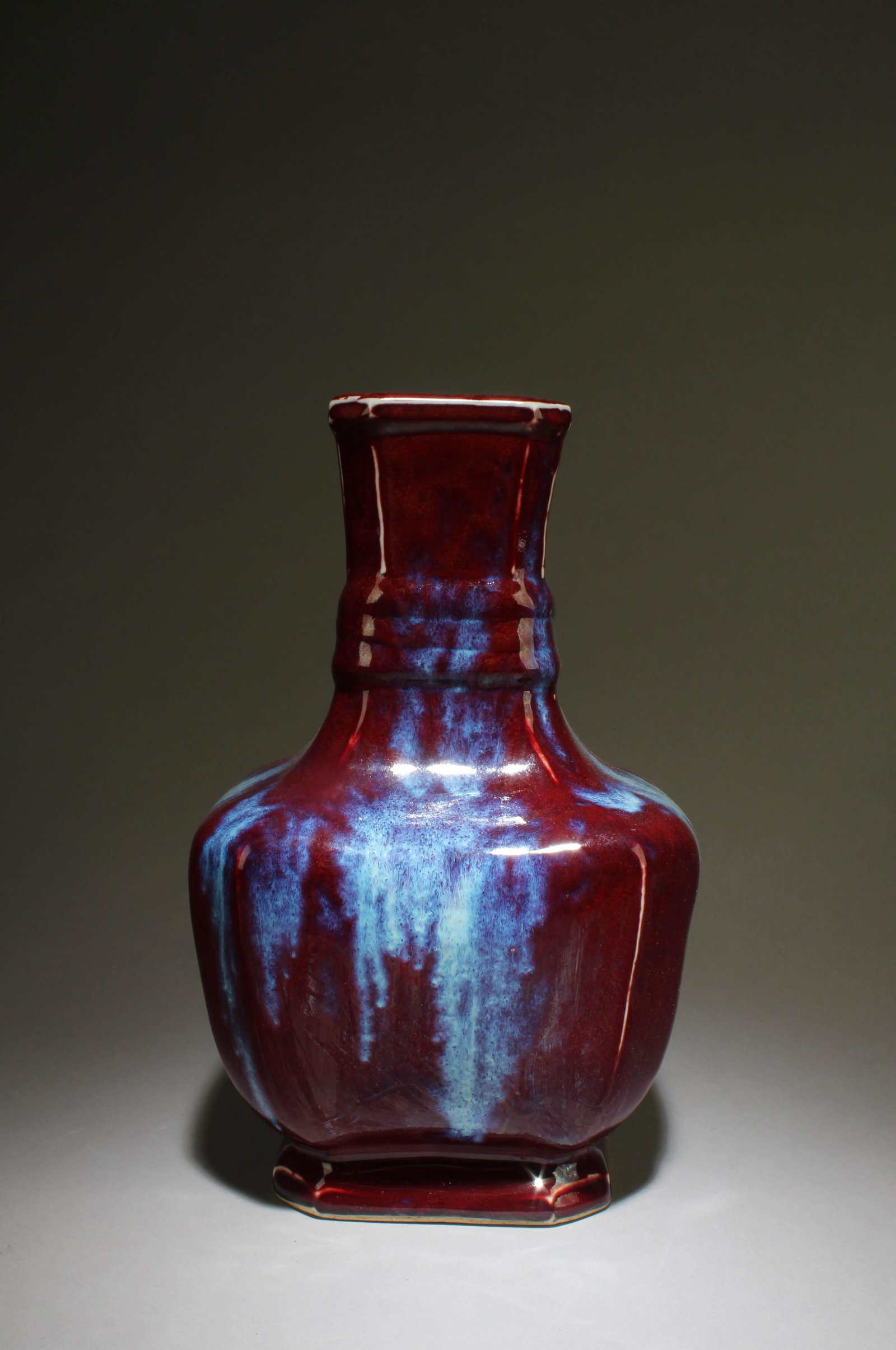 A Red Chinese Vase with White Accents: A Red Chinese Vase with White Accent with four Chinese Characters on the bottom. Dimensions: 10.5" x 6.5".