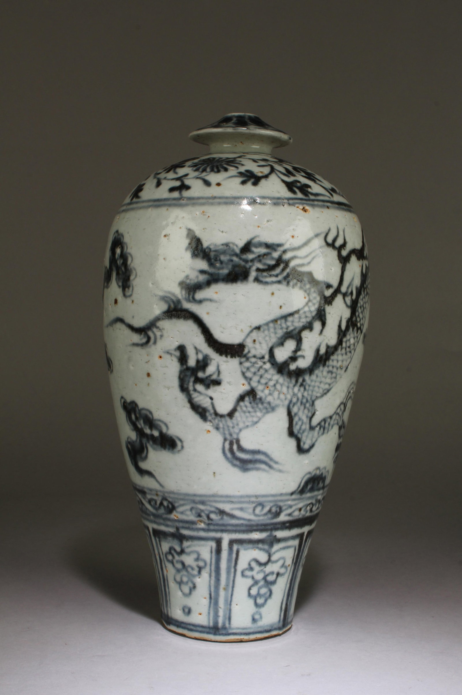 Extremely Rare Umbrella-mouth Vase: It has an elongated body resembling the long body Yuan Meiping. The thick and very heavy body is made of coarse and very hard clay. The glaze is grayish and has totally lost the shine of newly fired p