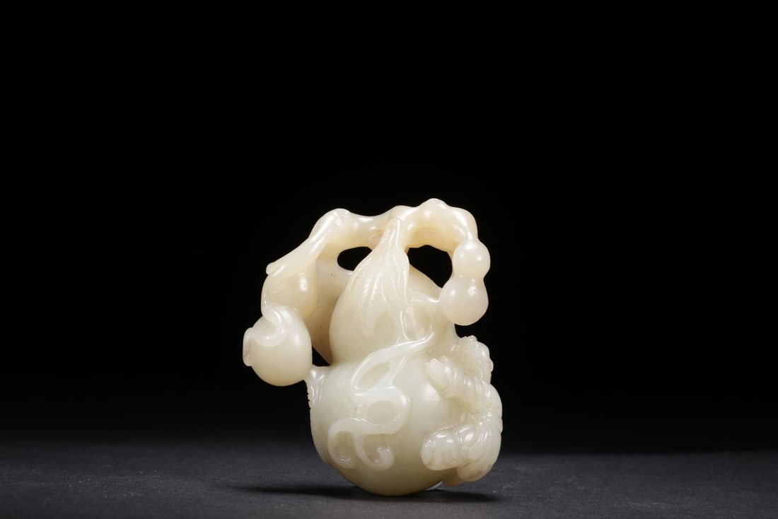 A Hetian Jade Ornament: A Hetian Jade Ornament. Dimensions: 1.69in x 1.30in x 2.24in Weight: 0.21lbs.