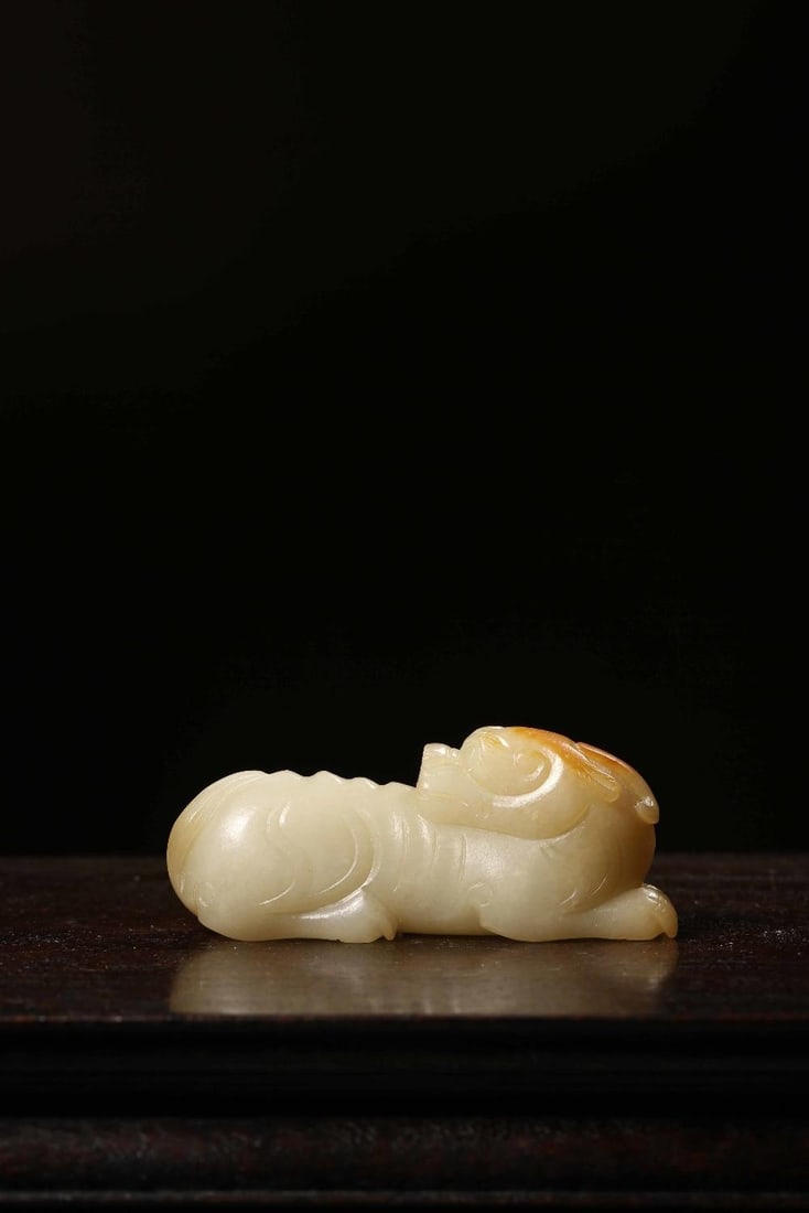 A Hetian Jade Beast Ornament: A Hetian Jade Beast Ornament. Dimensions: 2.95in x 0.87in x 0.87in Weight: 0.18lbs.