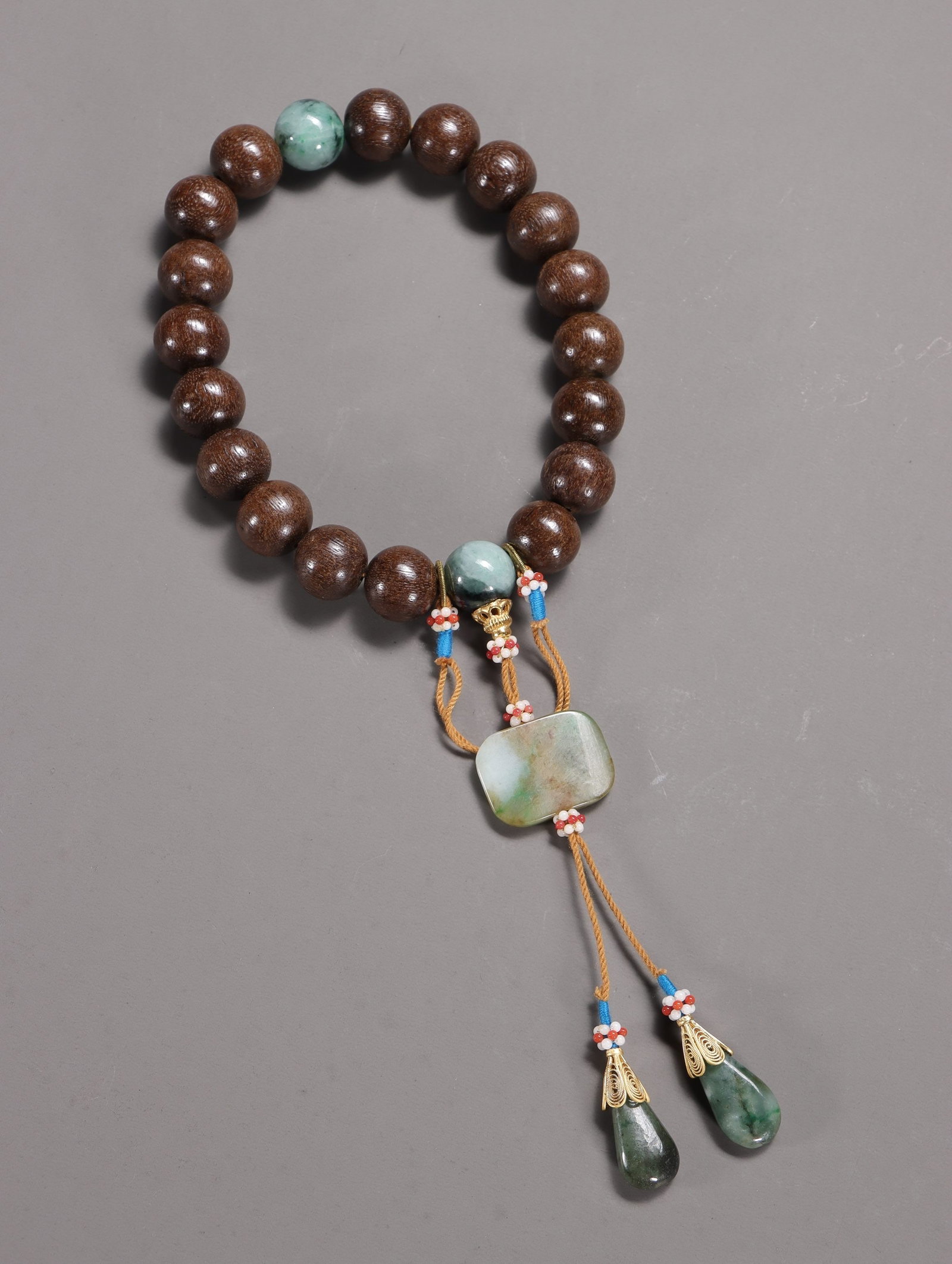 A String of Agarwood and Jade Prayer Beads: A String of Agarwood and Jade Prayer Beads. Diameter: 0.63in Weight: 0.17lbs.