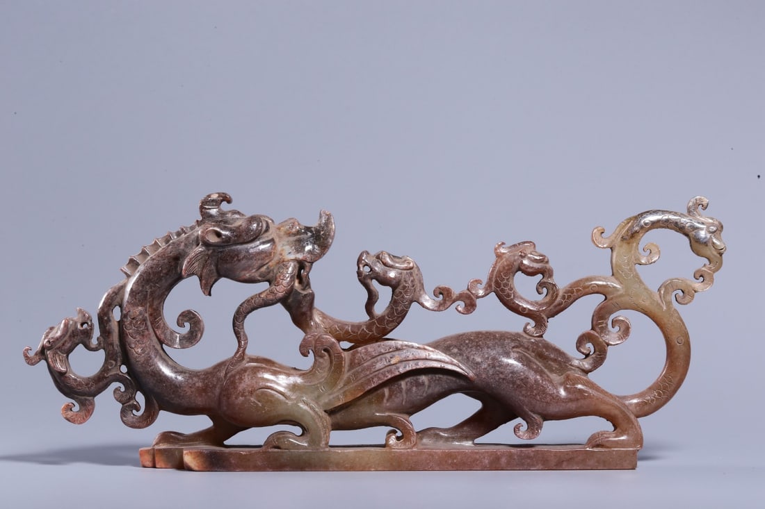 An Archaic Jade Ornament: An Archaic Jade Ornament. Dimensions: 2.95in x 7.68in x 0.83in Weight: 0.53lbs.