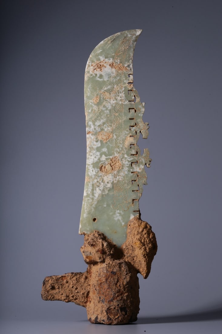 An Archaic Jade Knife: An Archaic Jade Knife. Dimensions: 2.36in x 13.39in x 5.12in Weight: 2.73lbs.