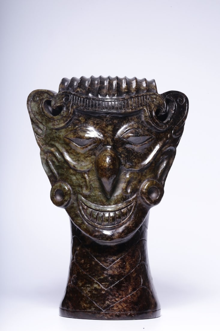 An Archaic Jade Head Ornament: An Archaic Jade Head Ornament. Dimensions: 7.09in x 4.72in x 3.35in Weight: 3.57lbs.