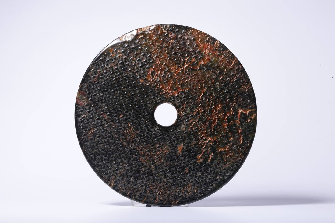 An Archaic Jade Bi Disc: An Archaic Jade Bi Disc. Height: 0.20in Diameter: 6.22in Weight: 0.66lbs.