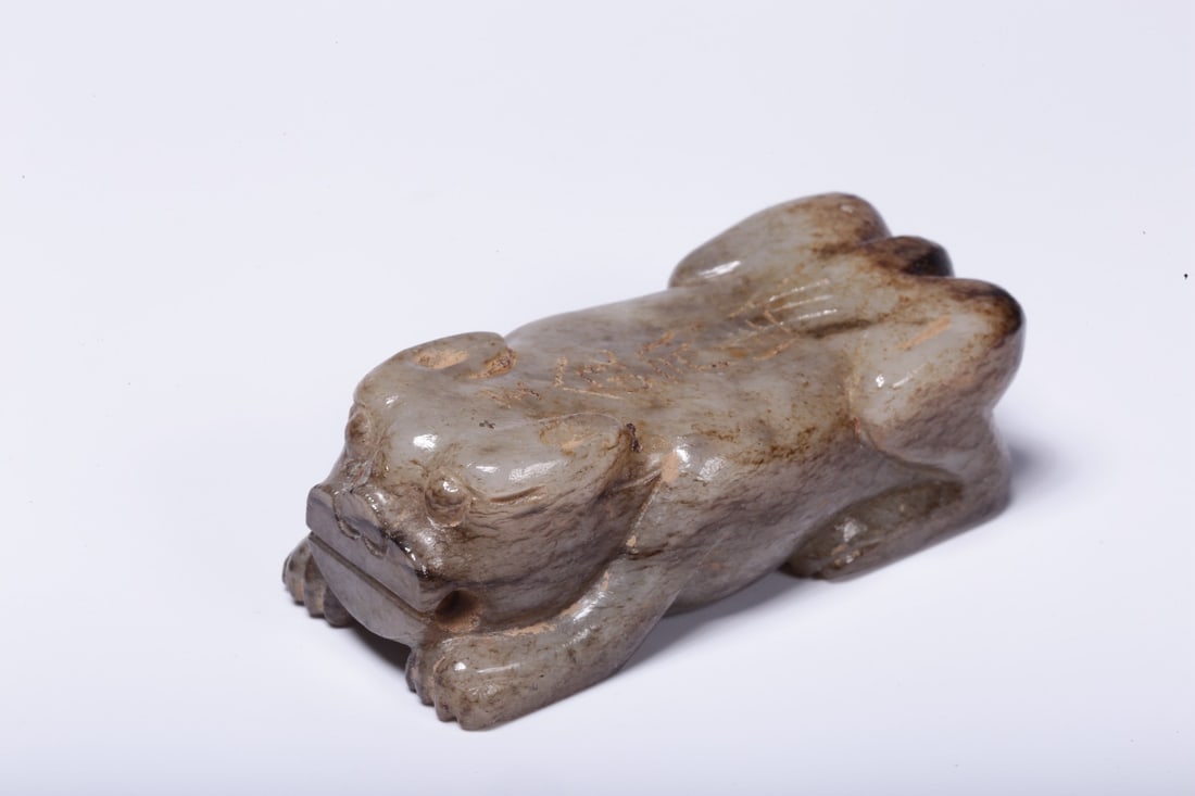 A Hetian Jade Beast Paperweight: A Hetian Jade Beast Paperweight. Dimensions: 0.75in x 2.28in x 0.98in Weight: 0.15lbs.