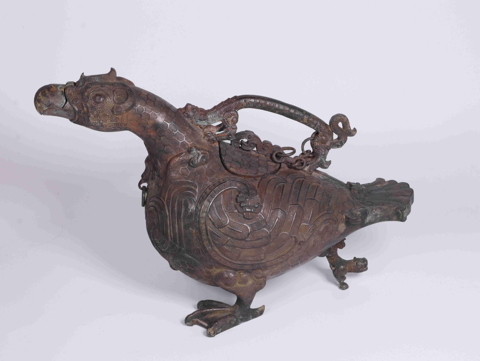 A Bronze Bird-Form Vessel: A Bronze Bird-Form Vessel. Dimensions: 14.17in x 6.30in x 9.84in.
