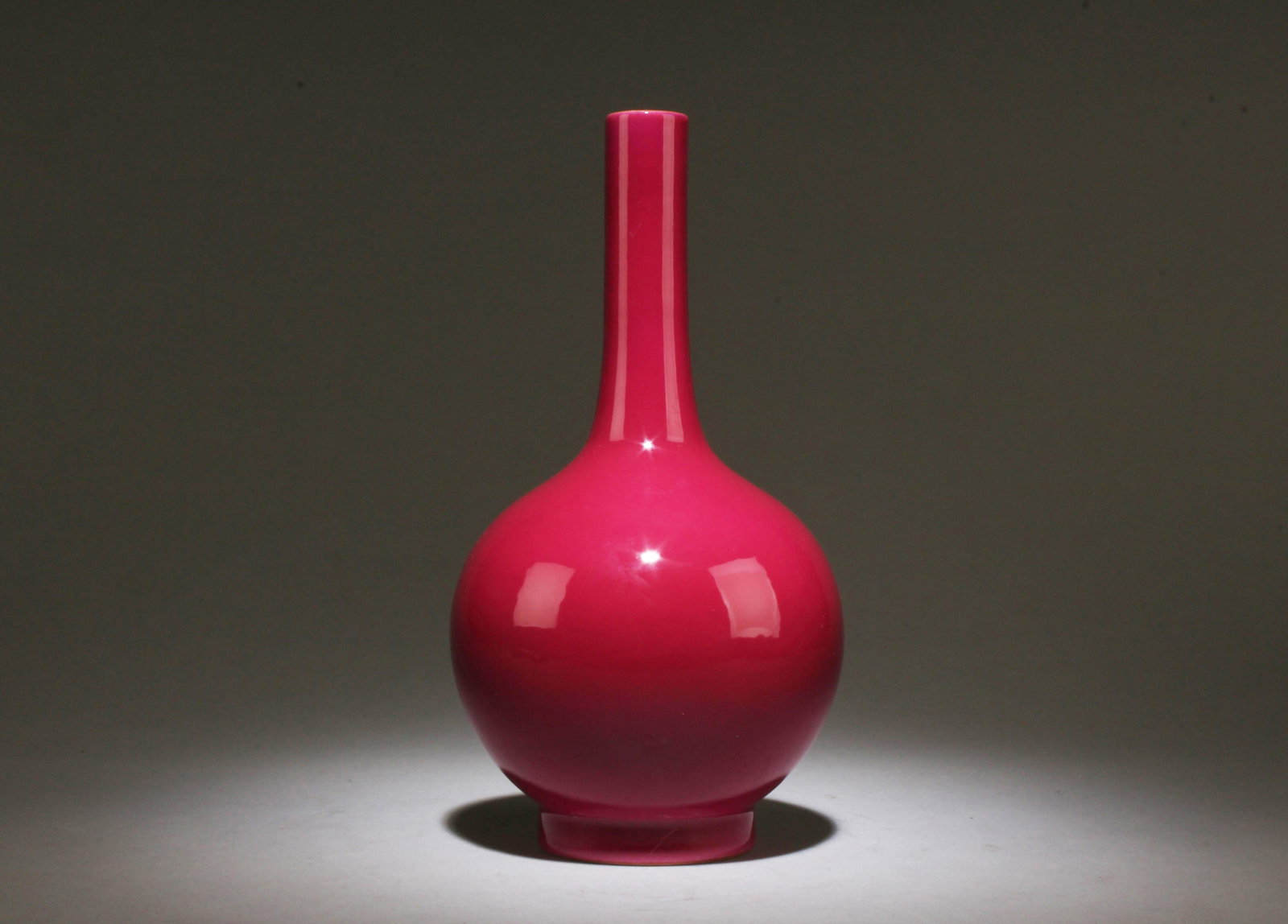 A Rogue Red Porcelain Vase: A Rogue Red Porcelain Vase. Dimensions: 9.75" x 5".