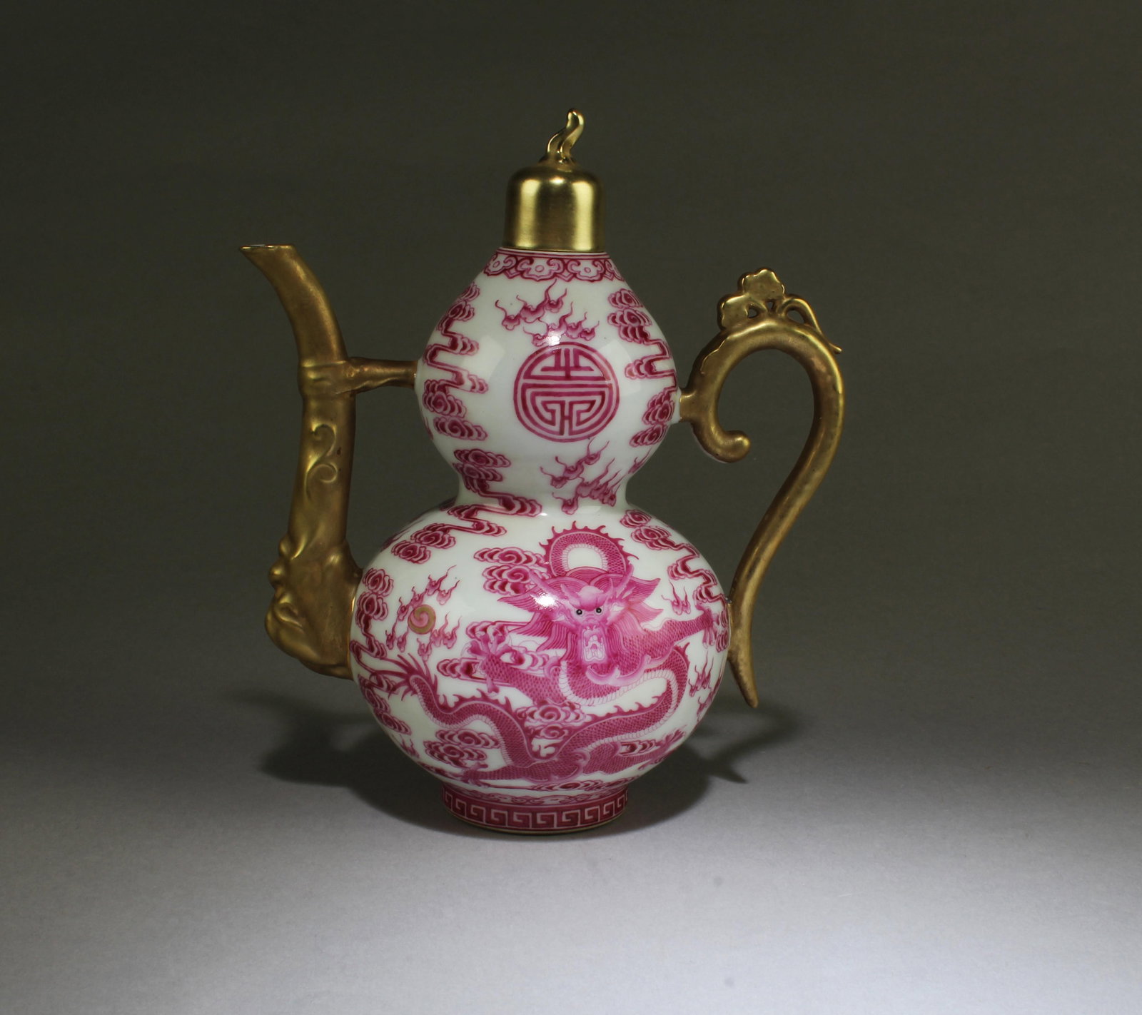 A Porcleain Teapot: A Porcleain Teapot, with gold color lid, the body depicting dragon. 'QianLong' mark. Height: 8.5"