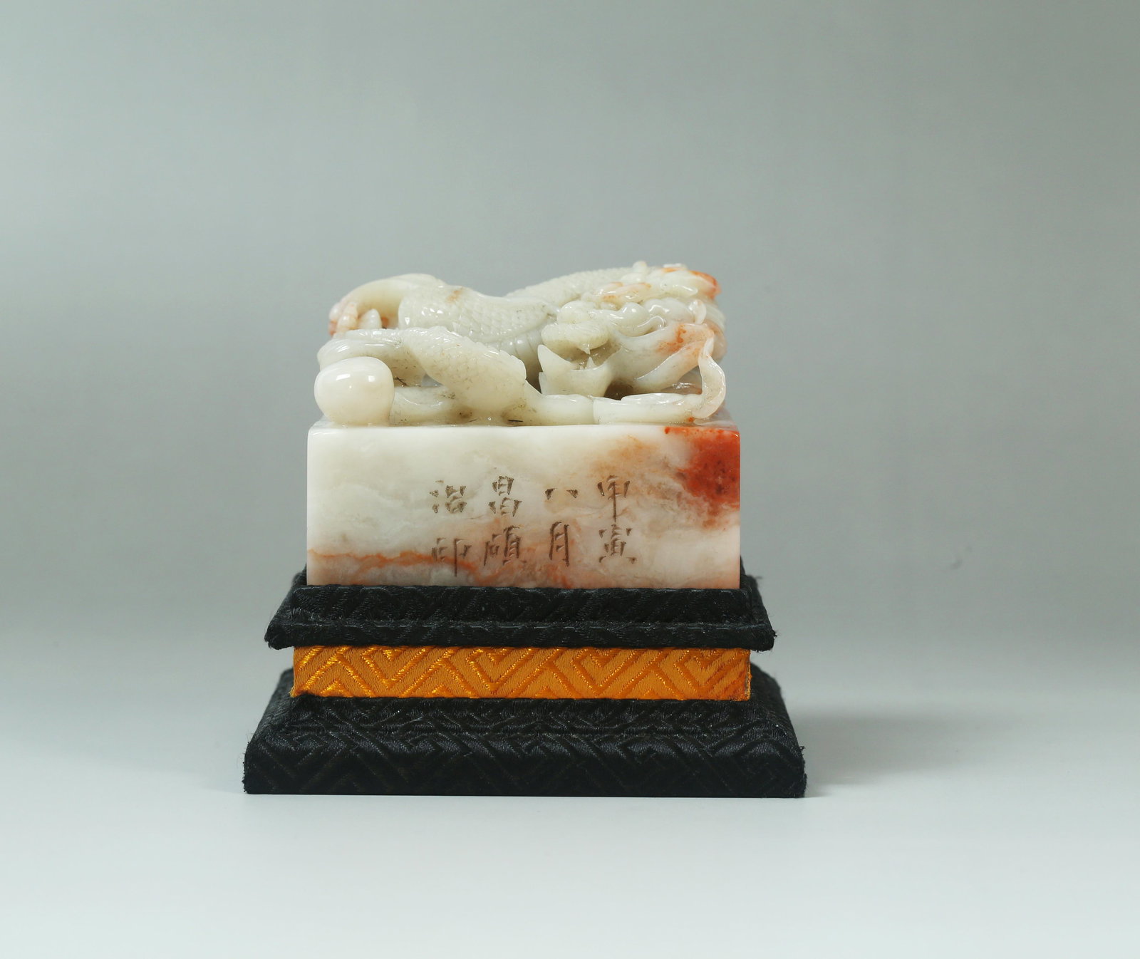 A Carved Stone Seal: A Carved Stone Seal. Comes fitted with a base. Length: 2.95in. Width: 2.95in. Height: 2.36in.