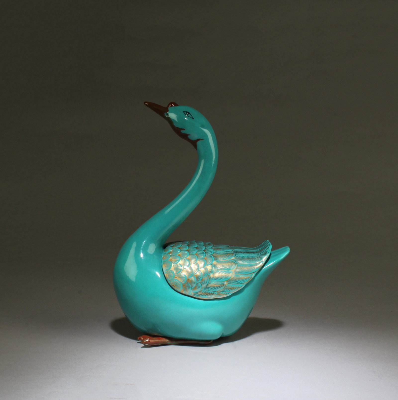 A Turquoise Color Porcelain Duck Figurine: A Turquoise Color Porcelain Duck Figurine. 'QianLong' mark. Height: 9"