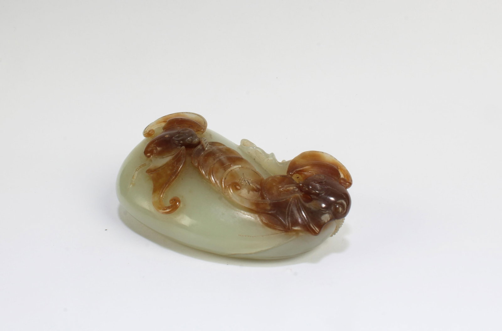 A Carved Jade Ornament: A Carved Jade Ornament. Length: 2.2"