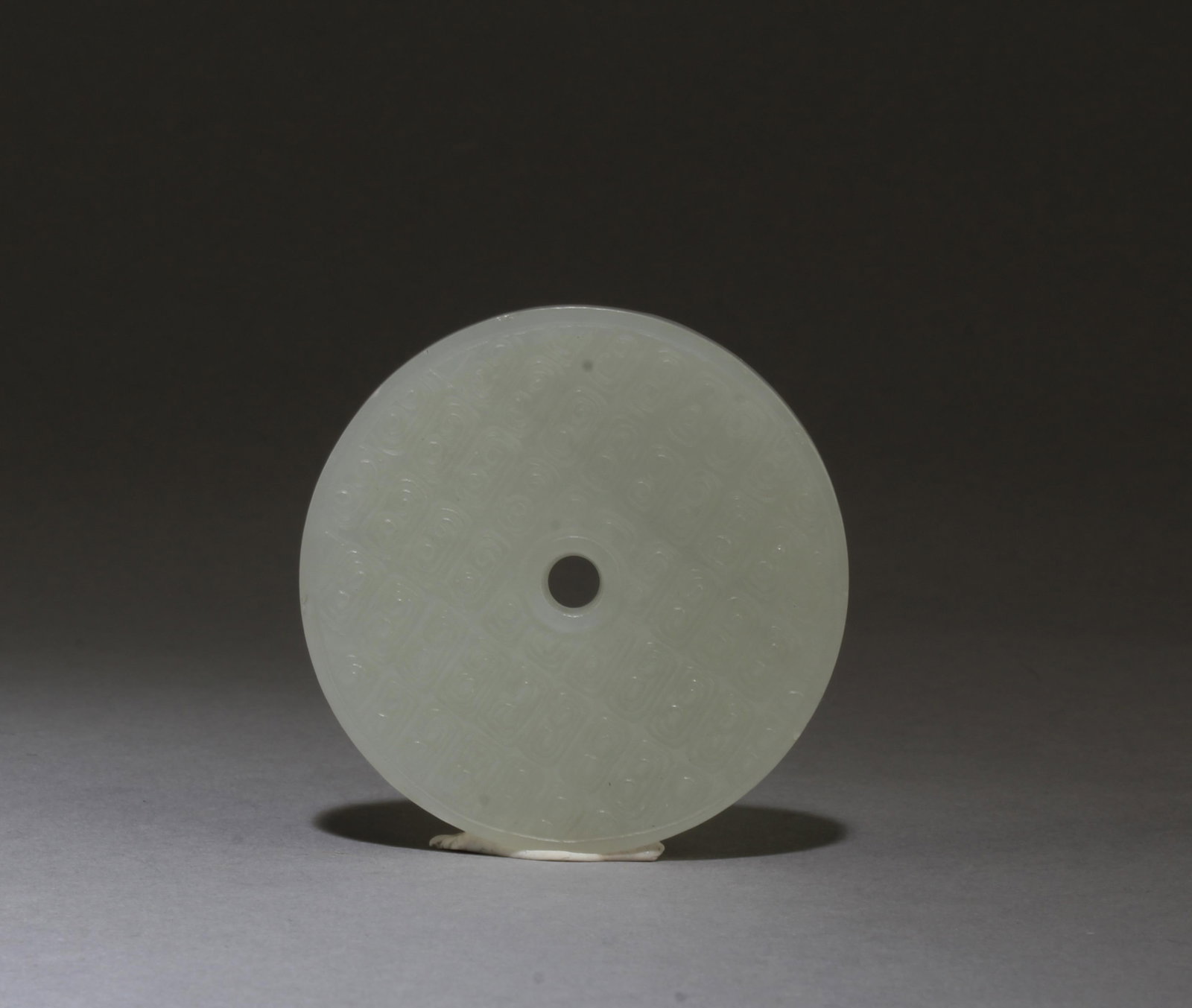 A Carved Round Shaped Jade Pendant: A Carved Round Shaped Jade Pendant. Diameter: 2.25"