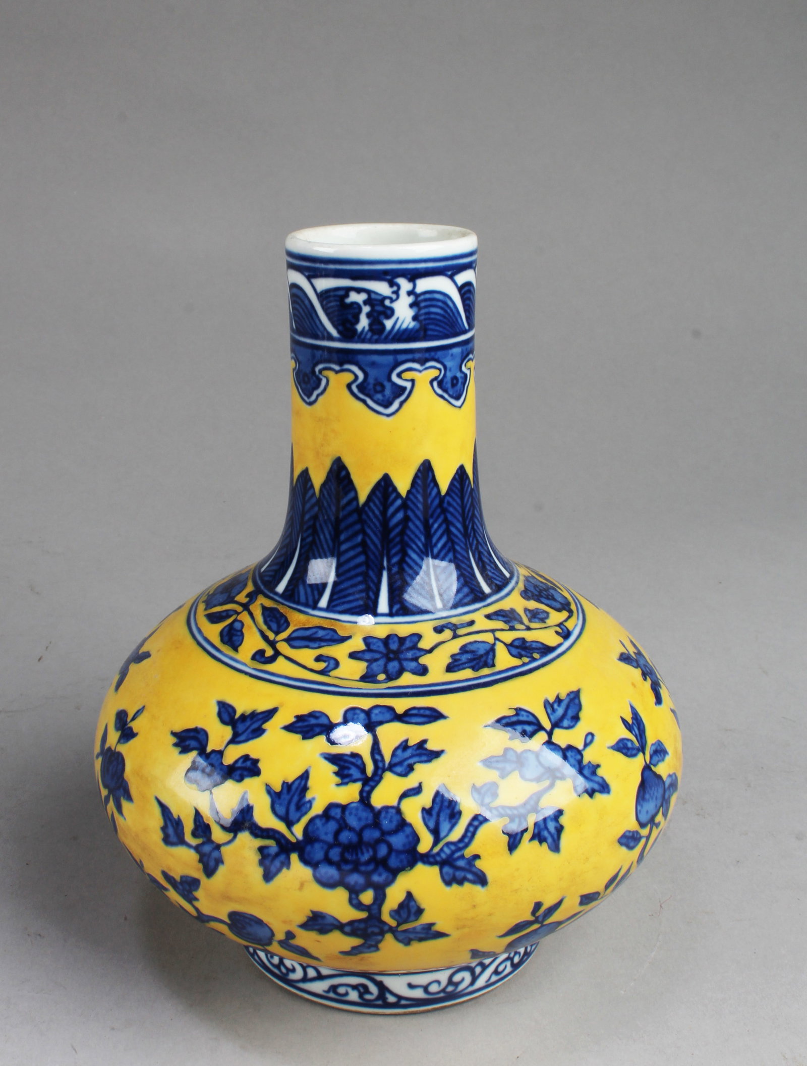 Chinese Flower Famille Jaune Porcelain Vase: Chinese Famille Jaune Porcelain Vase. 'QianLong' at base. Height: 7.5"
