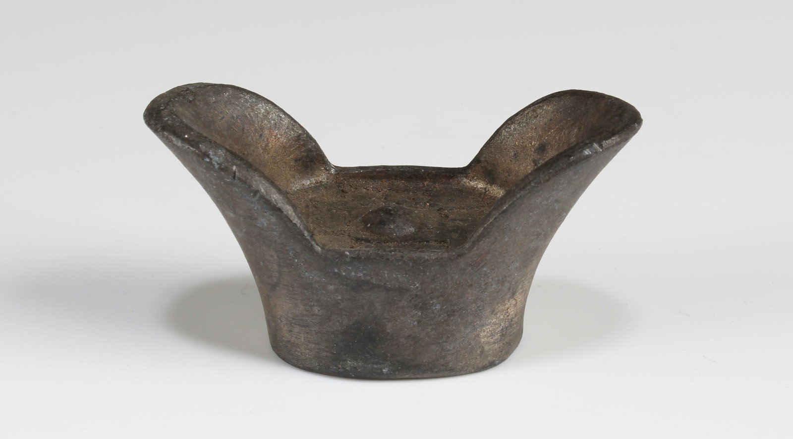 A Tael-Shaped Decorative Ornament: A Tael-Shaped Decorative Ornament. Length: 2"