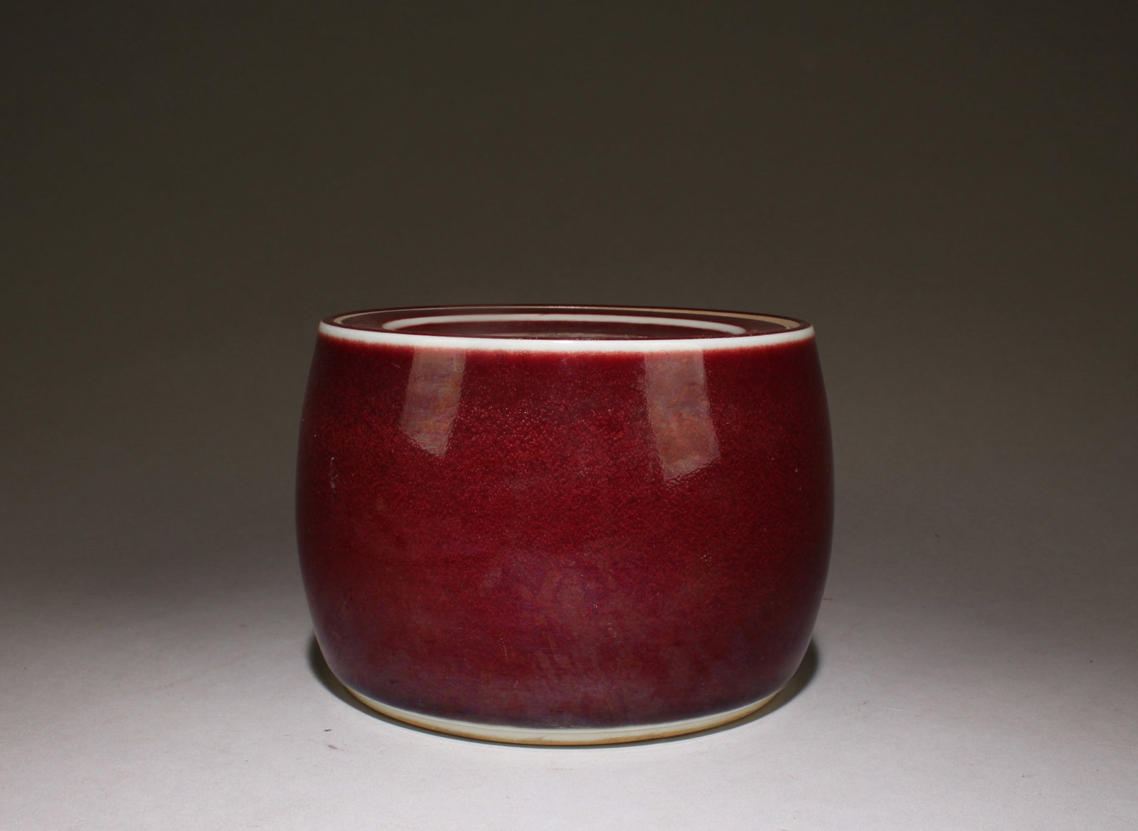 A Sang de Boeuf Glazed Cricket Pot: A Sang de Boeuf Glazed Cricket Pot. Dimensions: 3.9" x 5.5".