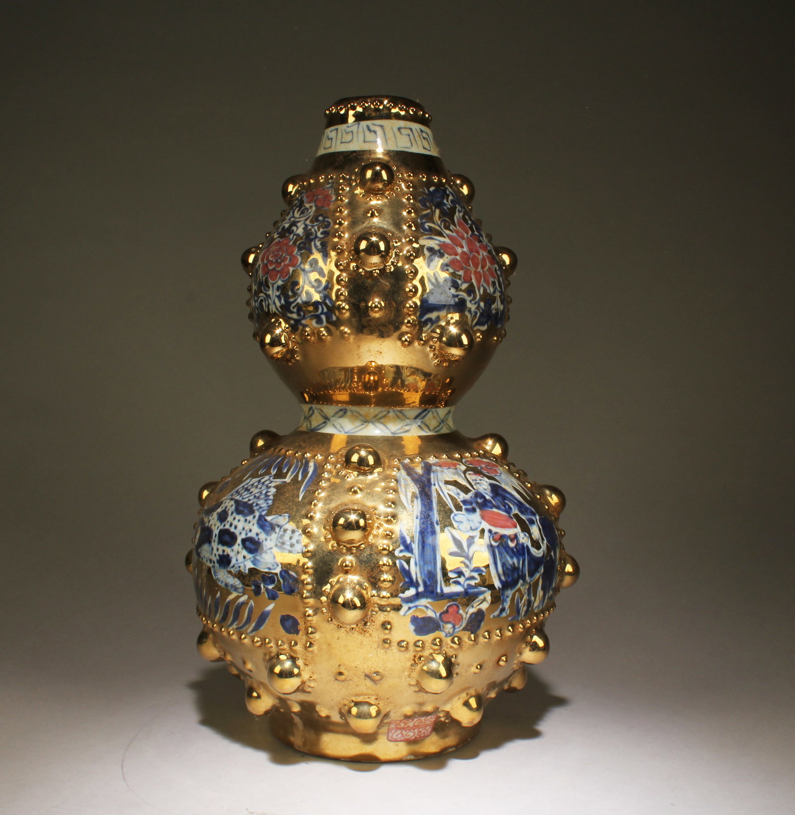 A Gilt Bronze Porcelain Gourd Vase: A Gilt Bronze Porcelain Gourd Vase. Dimensions: 14." x 9.5".